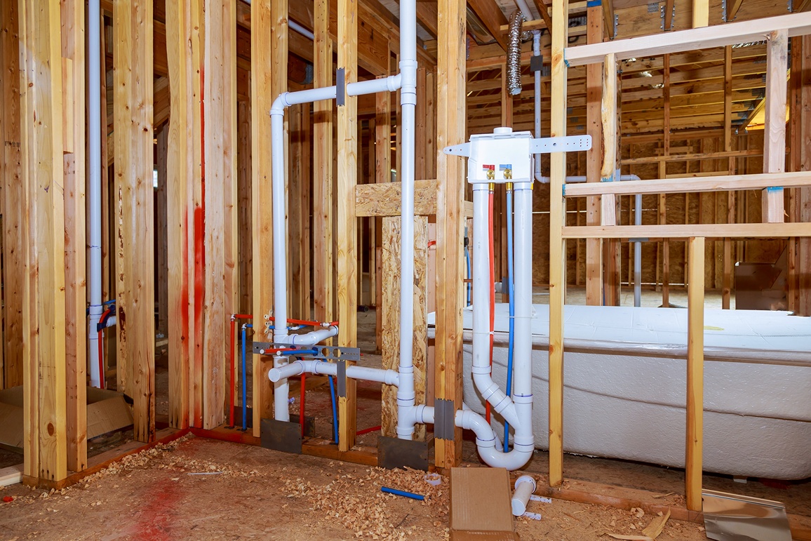 rough plumbing electrical and HVAC installation inside walls during stages of building a house