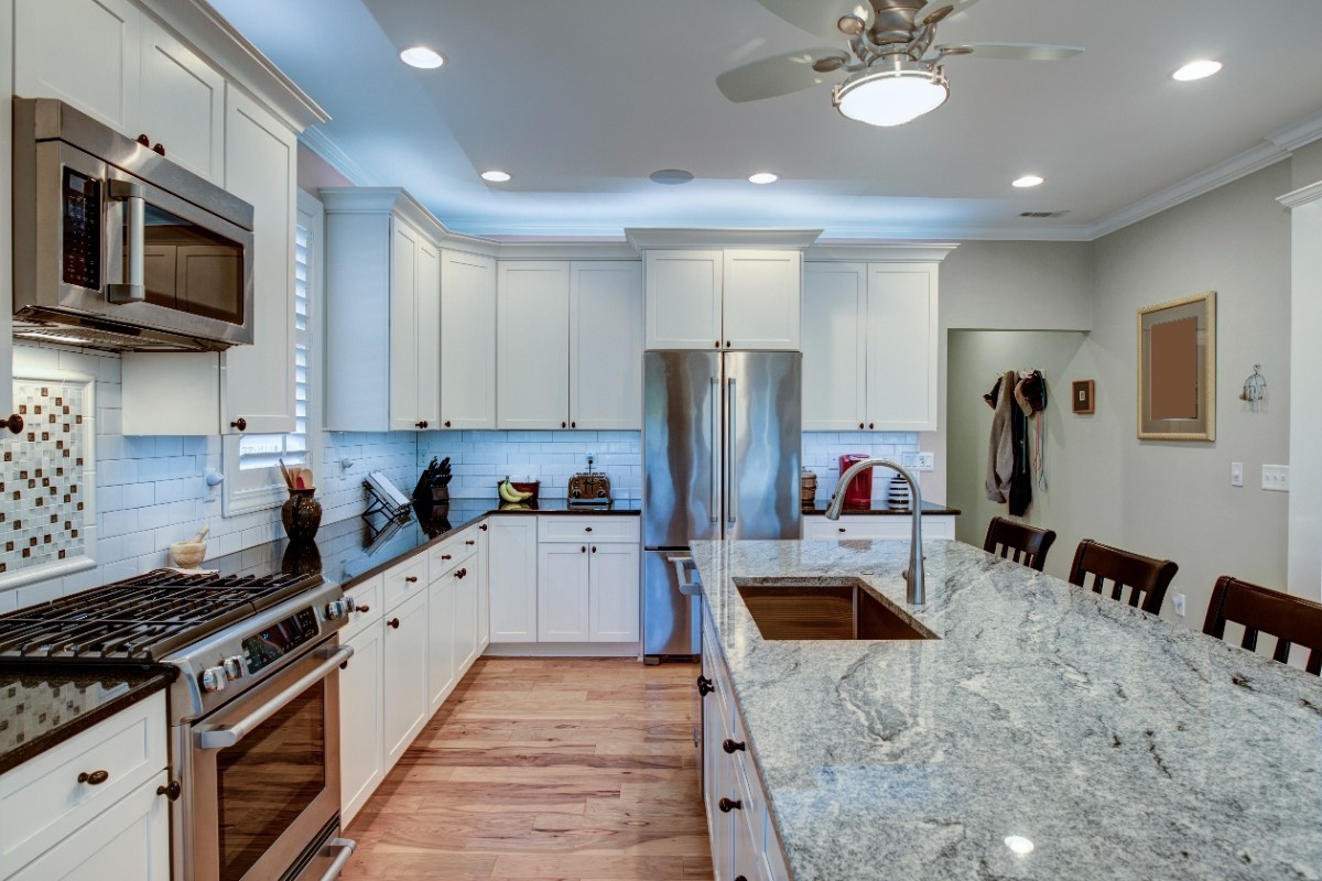 Newly remodeled kitchen in an Everett, WA home with white quartz countertops, custom cabinets, and a large center island
