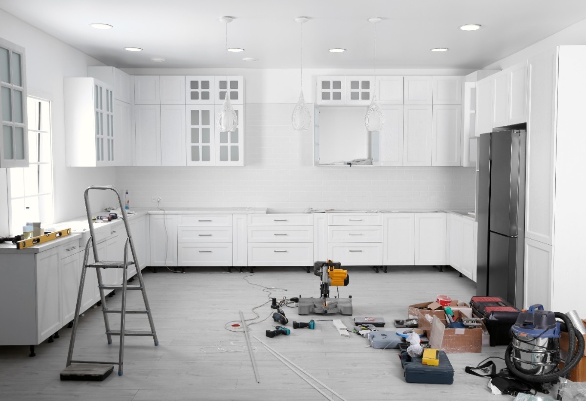 Kitchen mid-remodel in Everett with tools on the floor and cabinets being installed during a full renovation