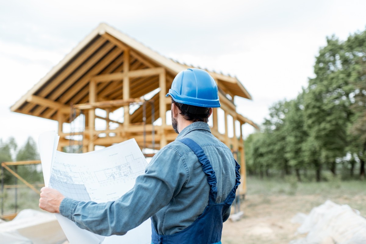 Everett home addition contractor checking house plans during construction process