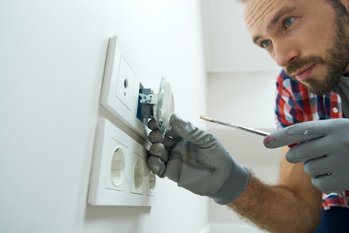 A bathroom remodeling contractor changing electrical outlet in an Everett bathroom