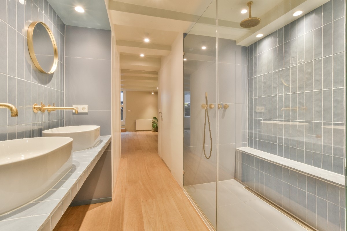 A newly remodeled bathroom in Everett with frameless walk-in shower and double sinks
