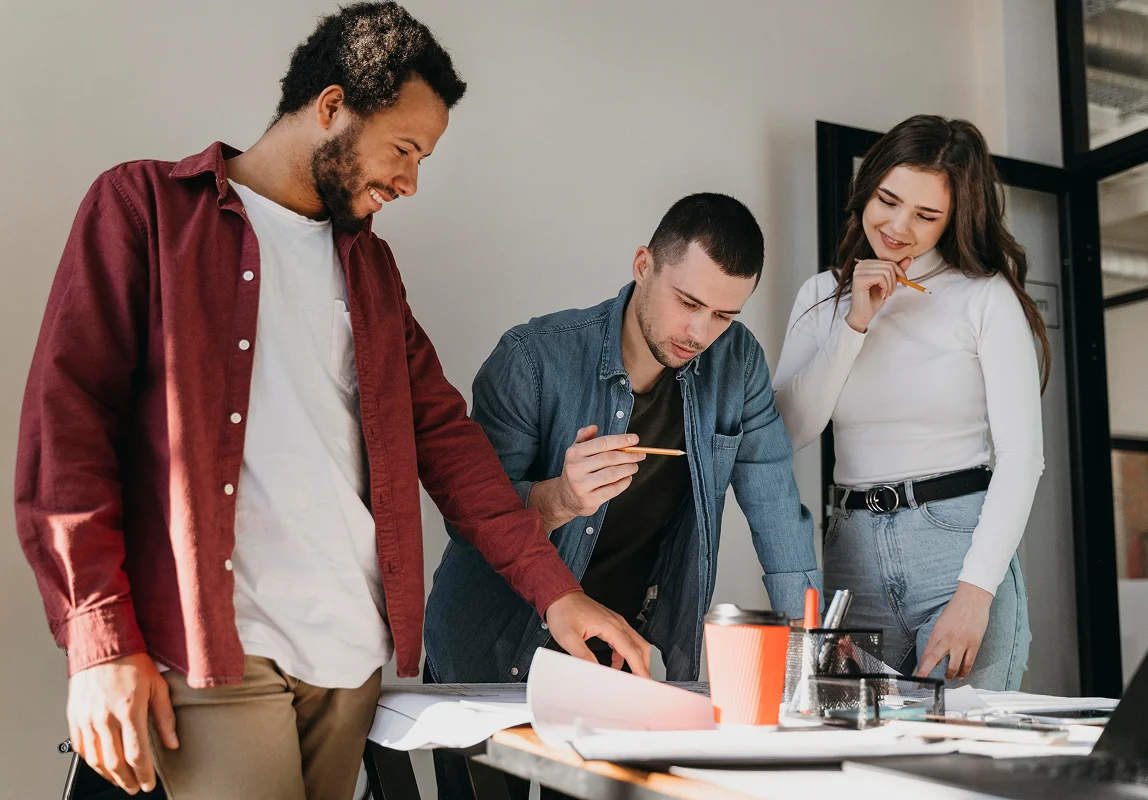 Three colleagues discussing outsourced advertising sales.