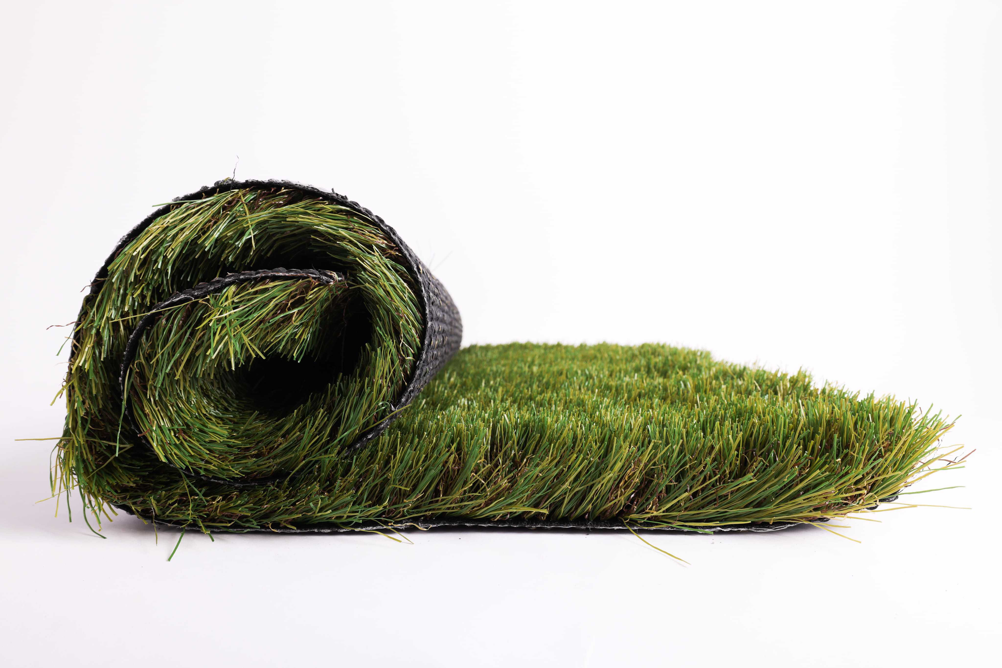 Rolled-up section of artificial green grass turf on a white background.