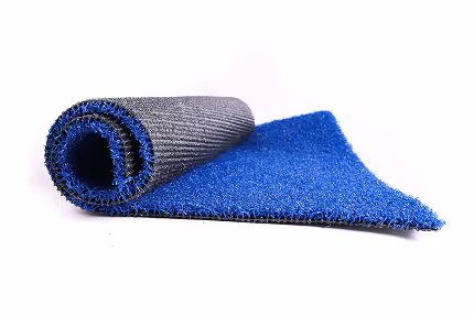 Partially rolled blue and gray textured mat on white background.