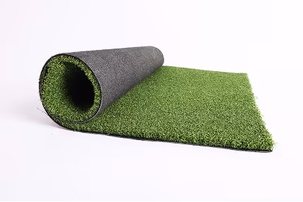 Rolled artificial green grass turf partially unrolled on a white background.