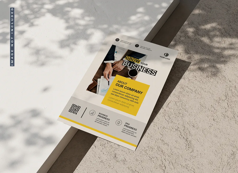 Business flyer on concrete surface with shadows, featuring a photograph of hands working on documents, headline 'Grow Your Business,' and a yellow box with company information.