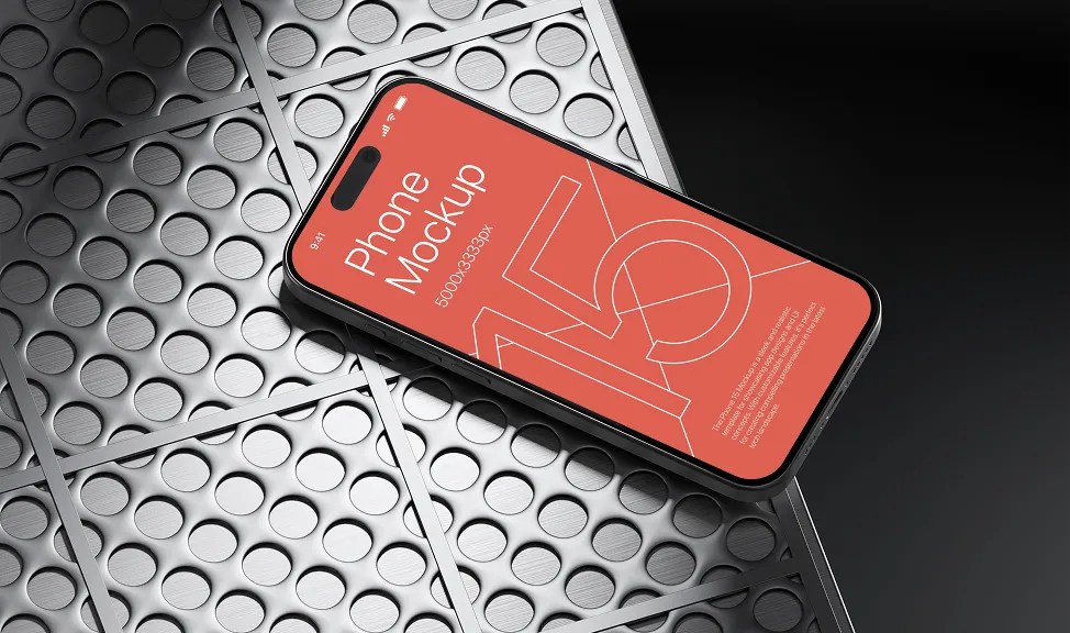 Modern smartphone with a red screen displaying 'Phone Mockup 5000x3339px' lying on a silver textured surface with circular indentations.