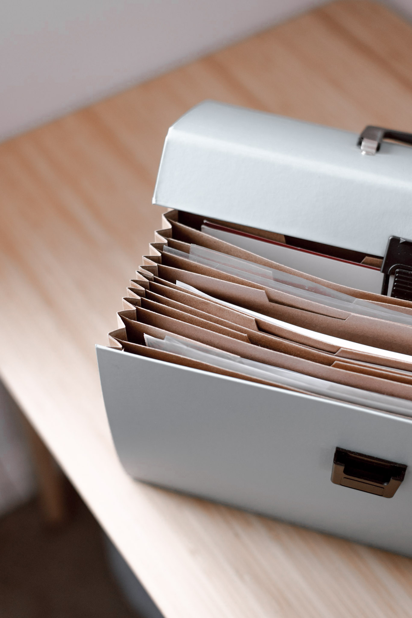 Organized document case with labeled folders on a desk