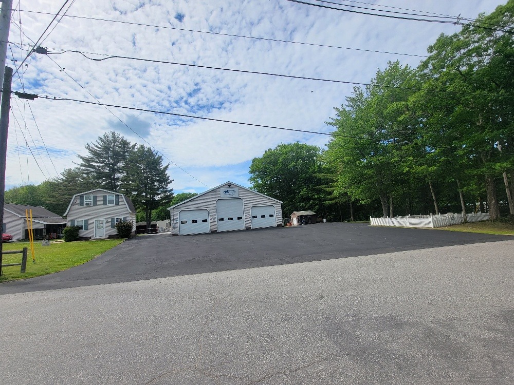 Freshly paved asphalt driveway and parking area