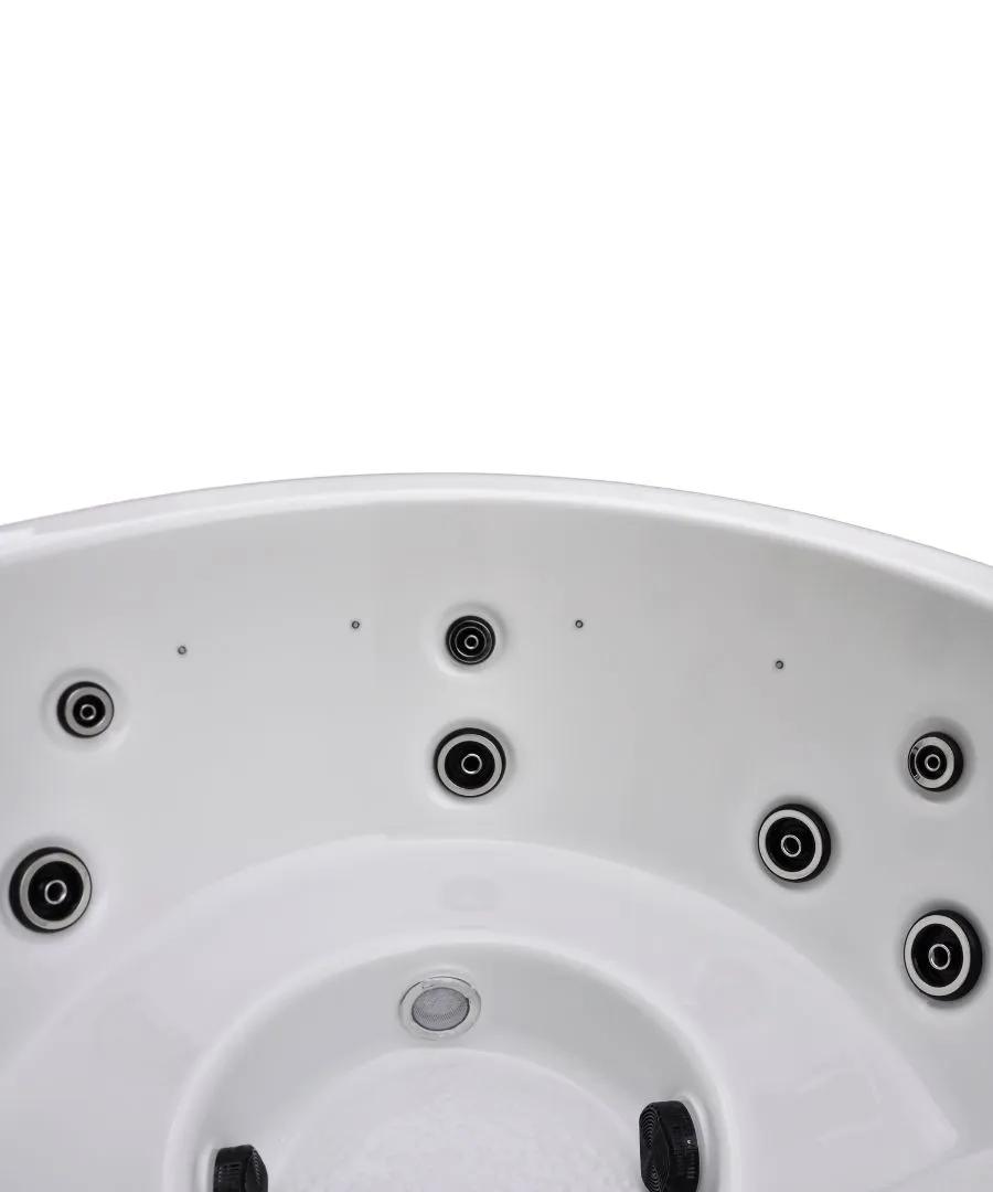 Whirlpool mit mehreren schwarzen Düsen auf weißer, runder Oberfläche