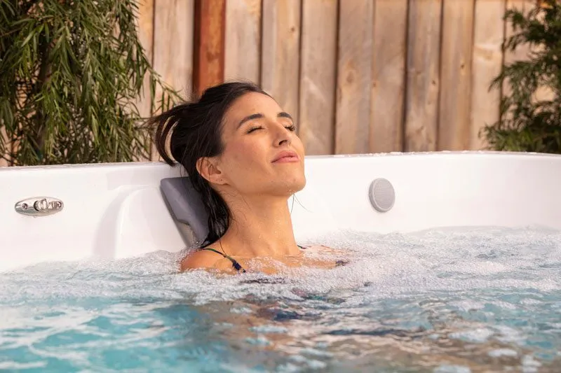 Frau entspannt auf einem Hydromassage-Platz eines Endless Pools SwimSpa