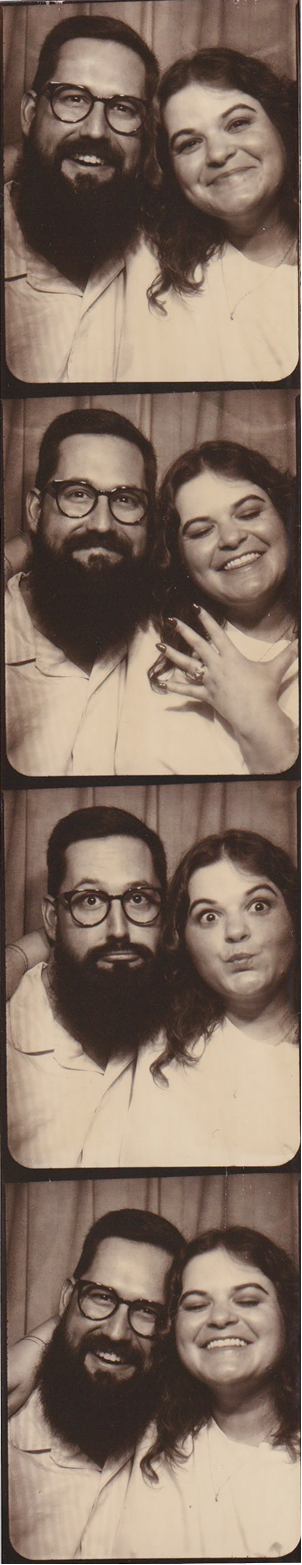 Four-panel black and white photo booth strip featuring a smiling bearded man with glasses and a smiling woman with curly hair posing closely together, showing happy and playful expressions.