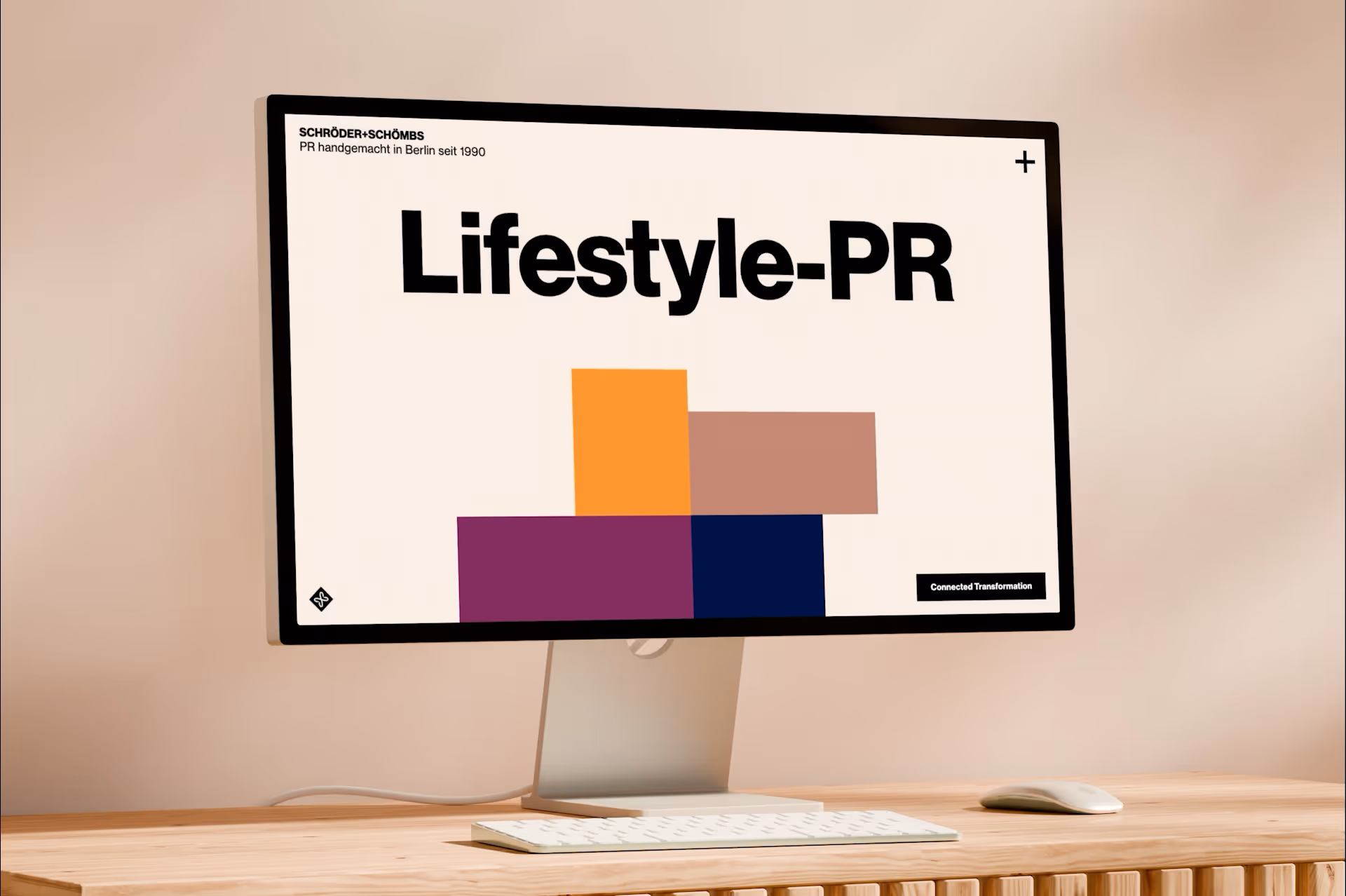 Desktop monitor on wooden desk displaying 'Lifestyle-PR' with colorful rectangles and text in German about PR in Berlin.