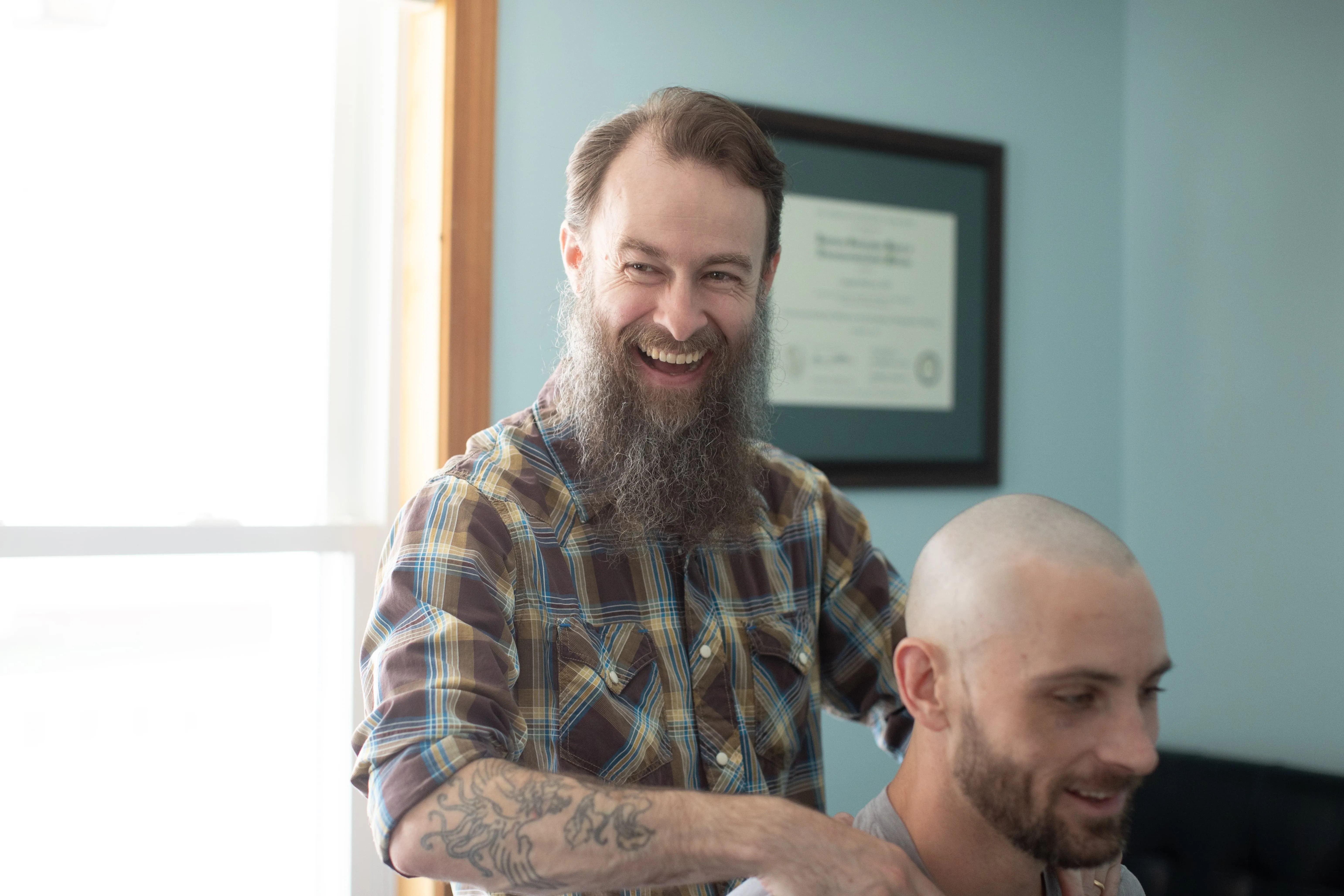 Dr. Joseph McCue laughing with a patient during a shoulder examination