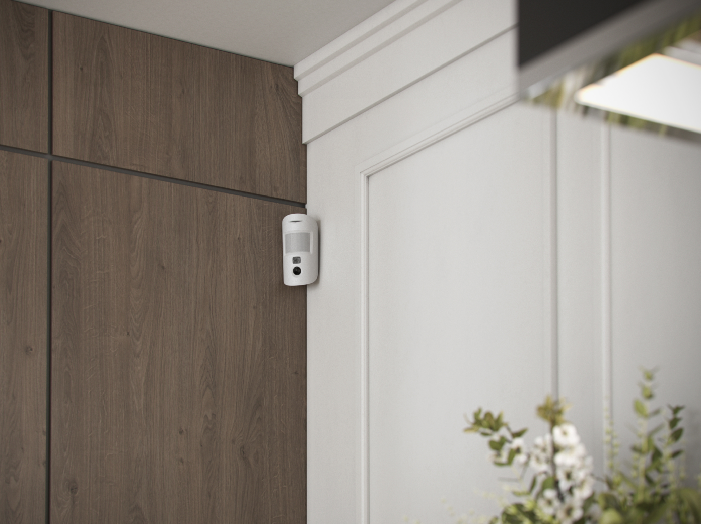 Ajax motion detector installed in a residential home detecting movement as part of a professional security system