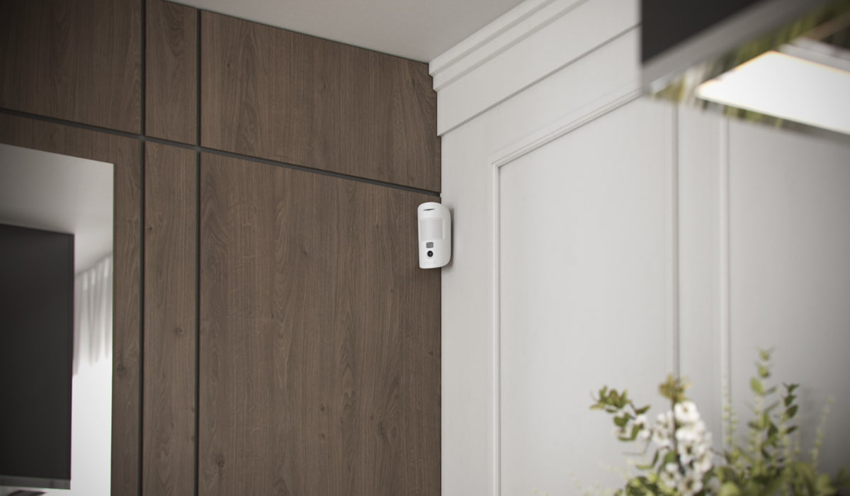 Ajax motion detection sensor installed inside a home to help confirm real activity as part of a professionally designed security system.