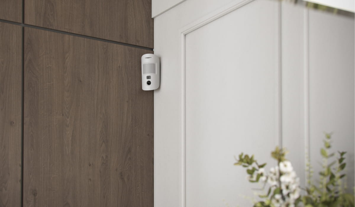 Ajax motion detector installed in a residential home detecting movement as part of a professional security system