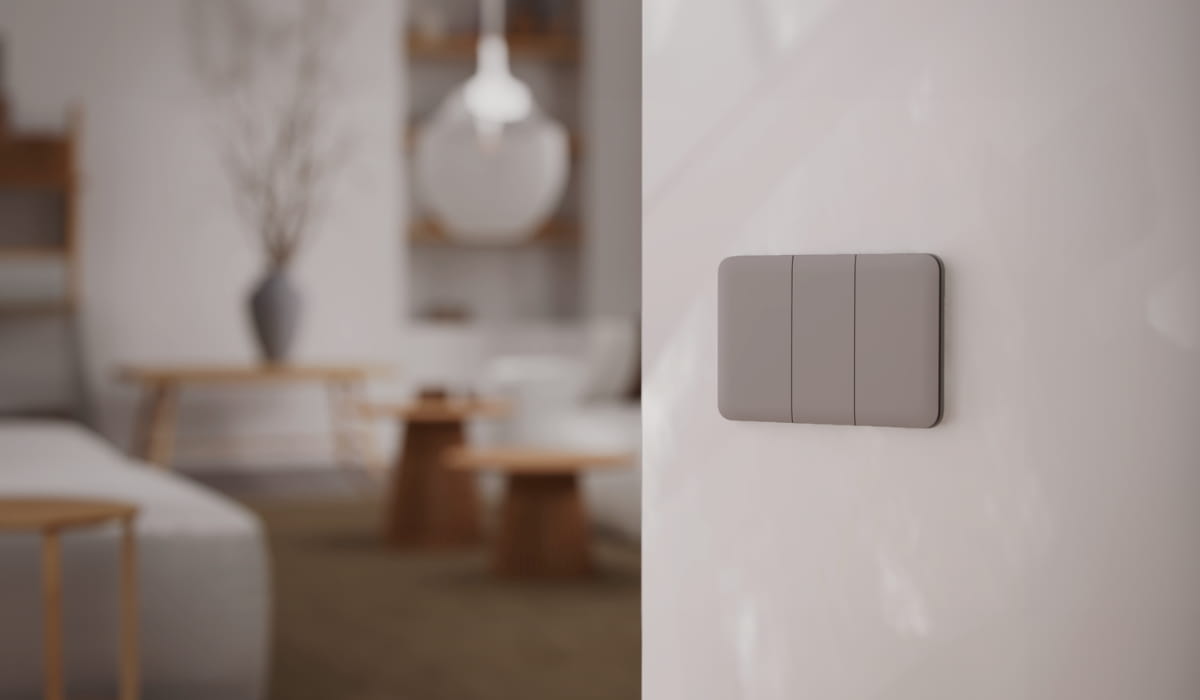 Ajax smart light switch installed on a wall in a modern home interior.