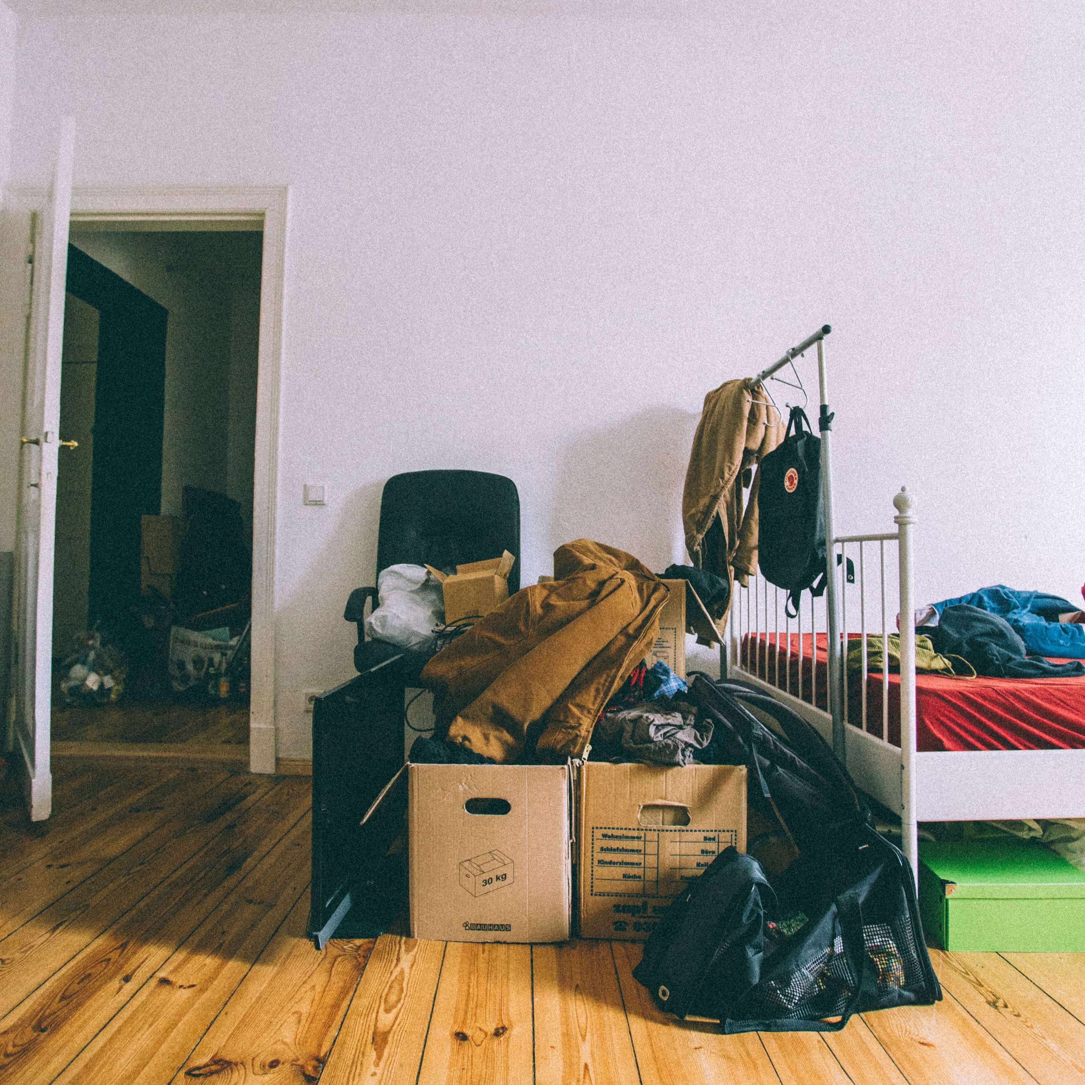 a bedroom fill with boxed and ready to be moced out