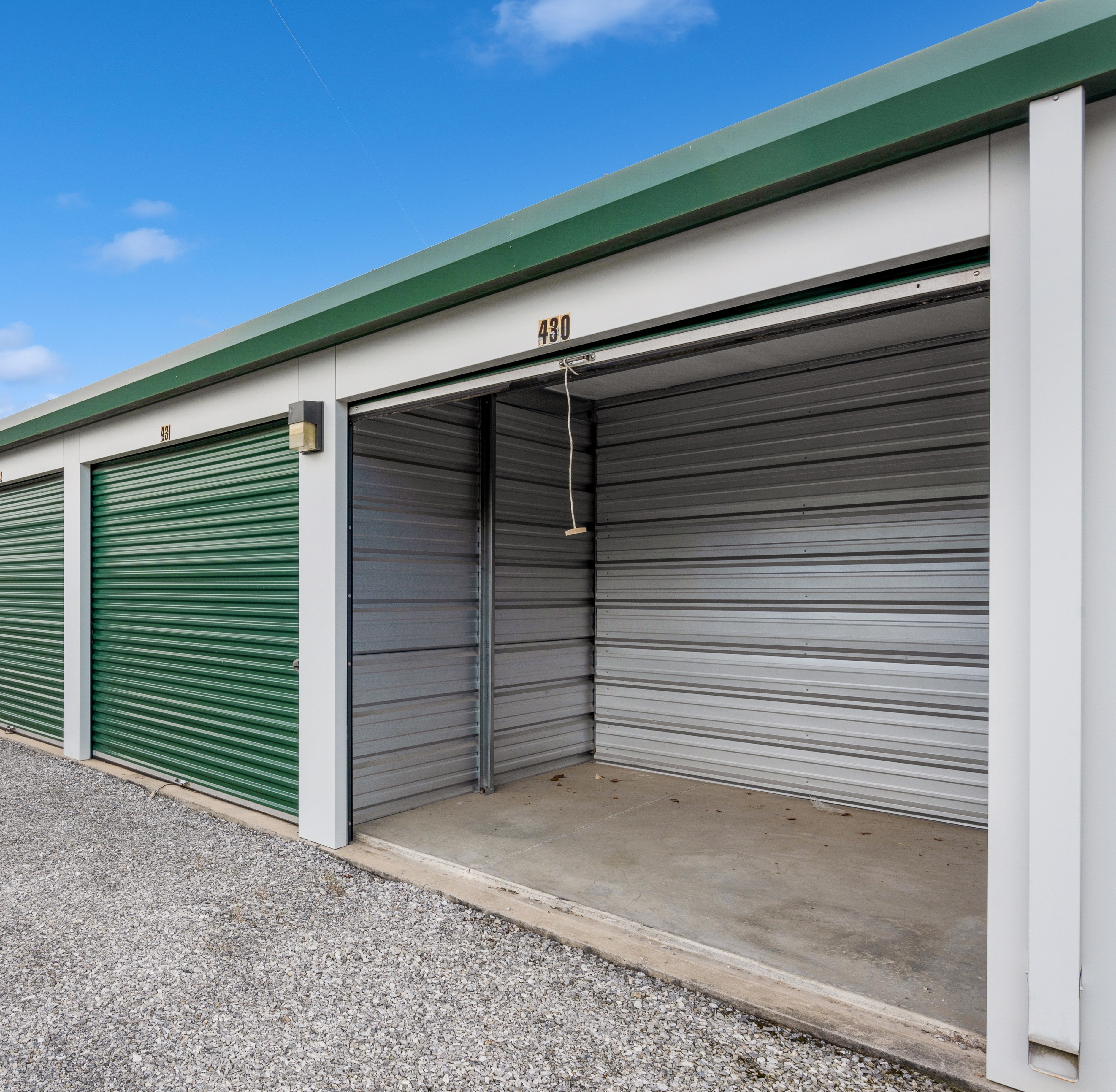 a sellf storage unit with a roll up door open
