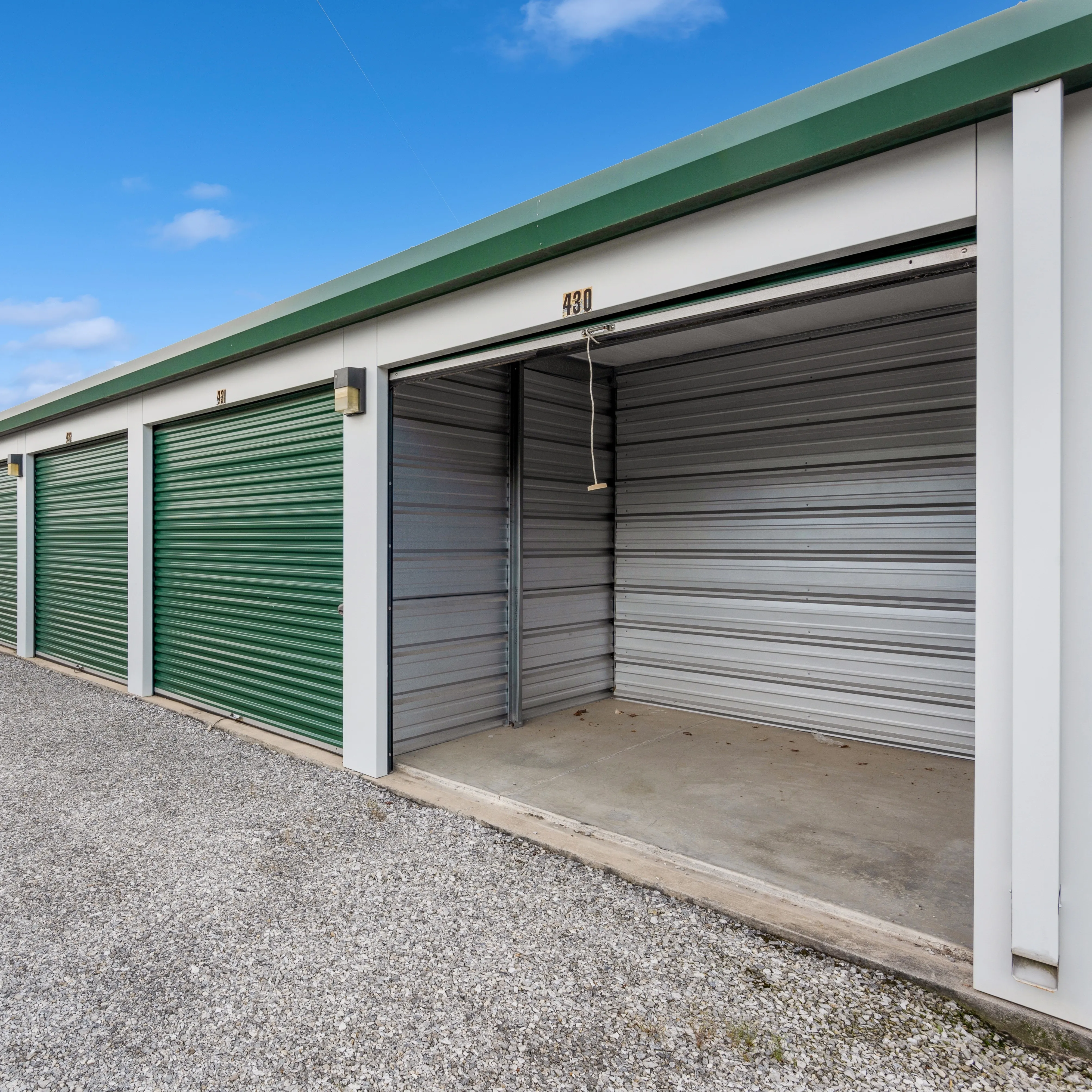 a sellf storage unit with a roll up door open