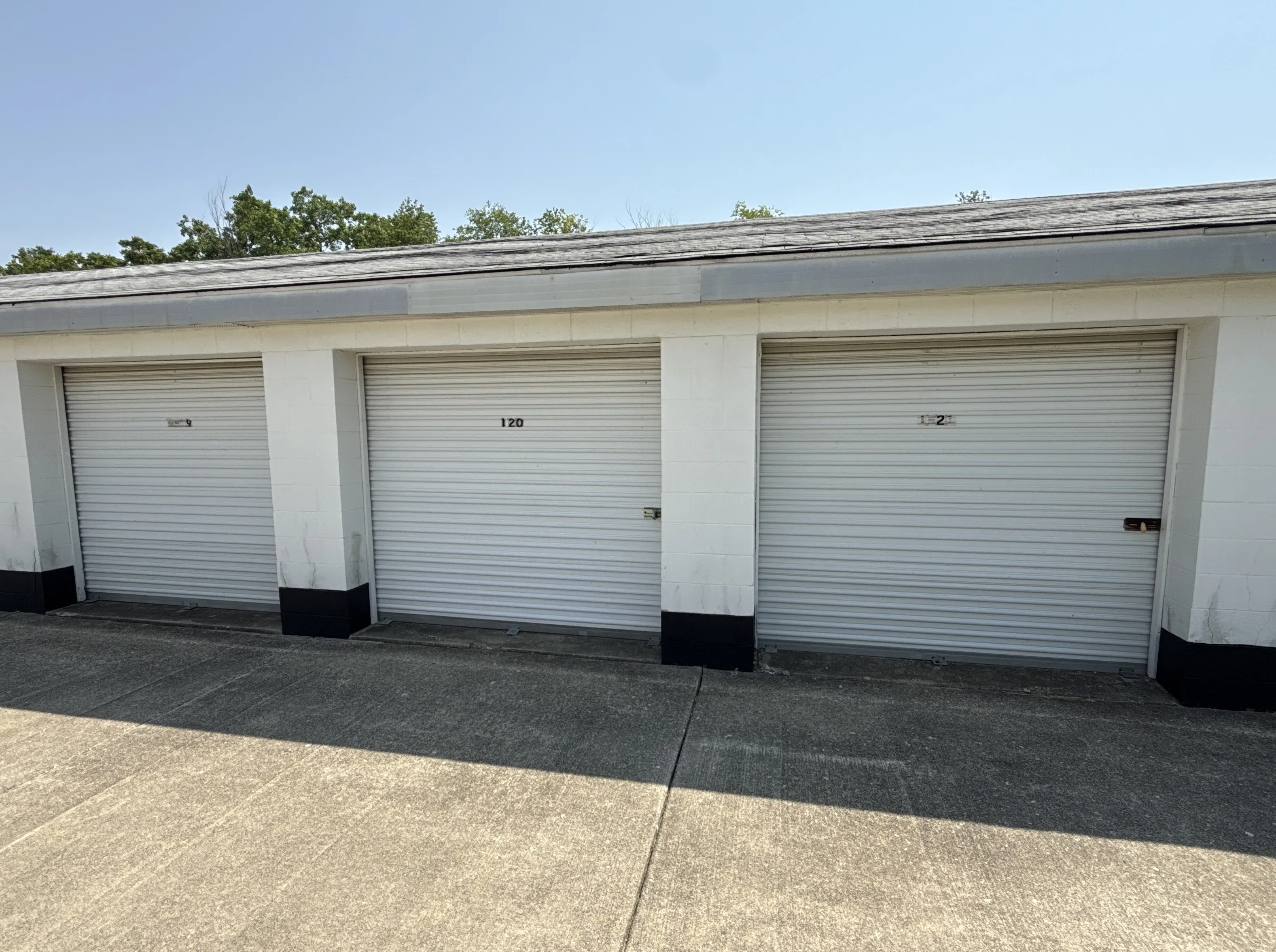 Row of drive up storage units with white roll up doors at our Kokomo IN facility