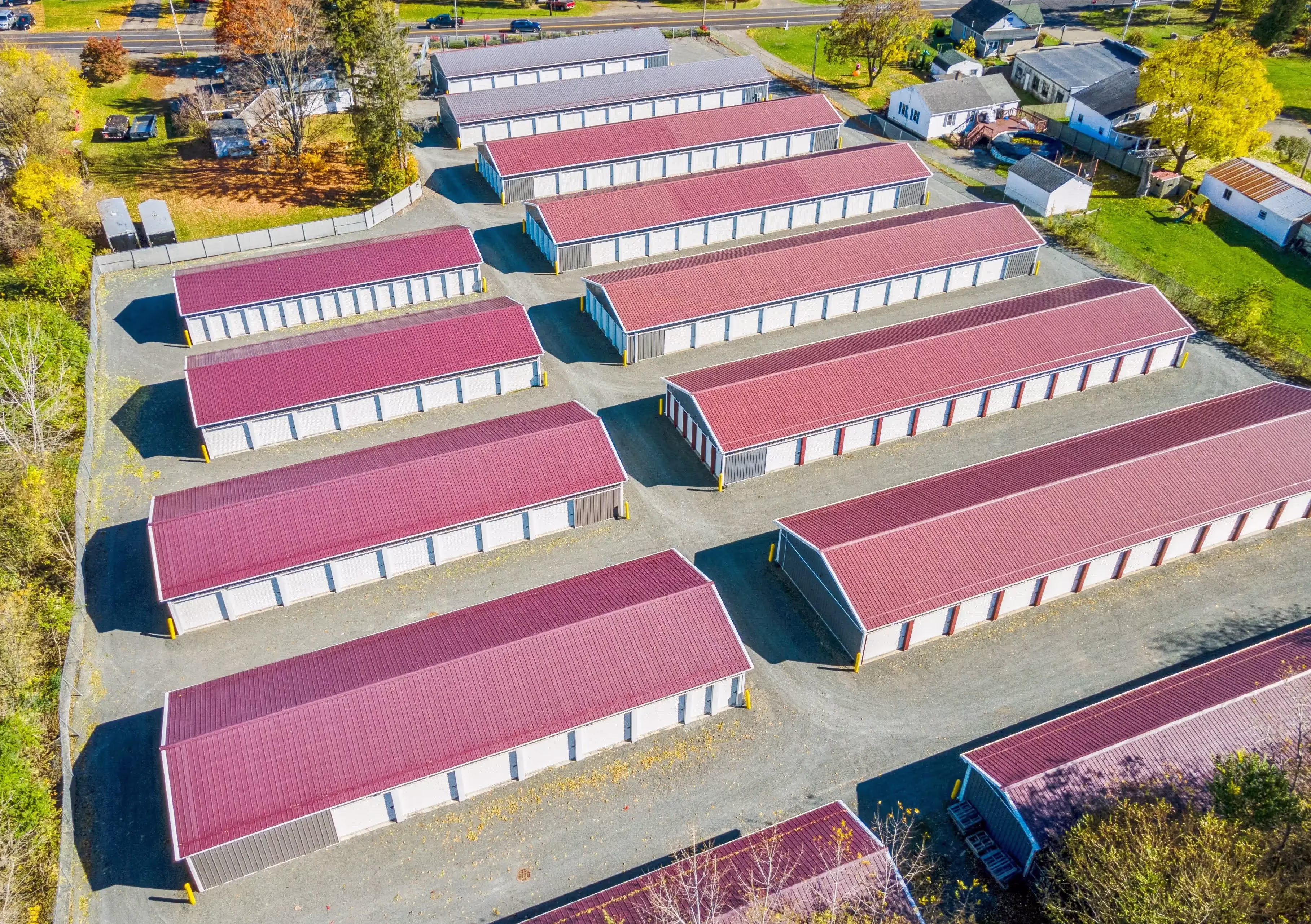 Aerial view of our Elmira NY self storage facility with rows of drive up units and purple roofs