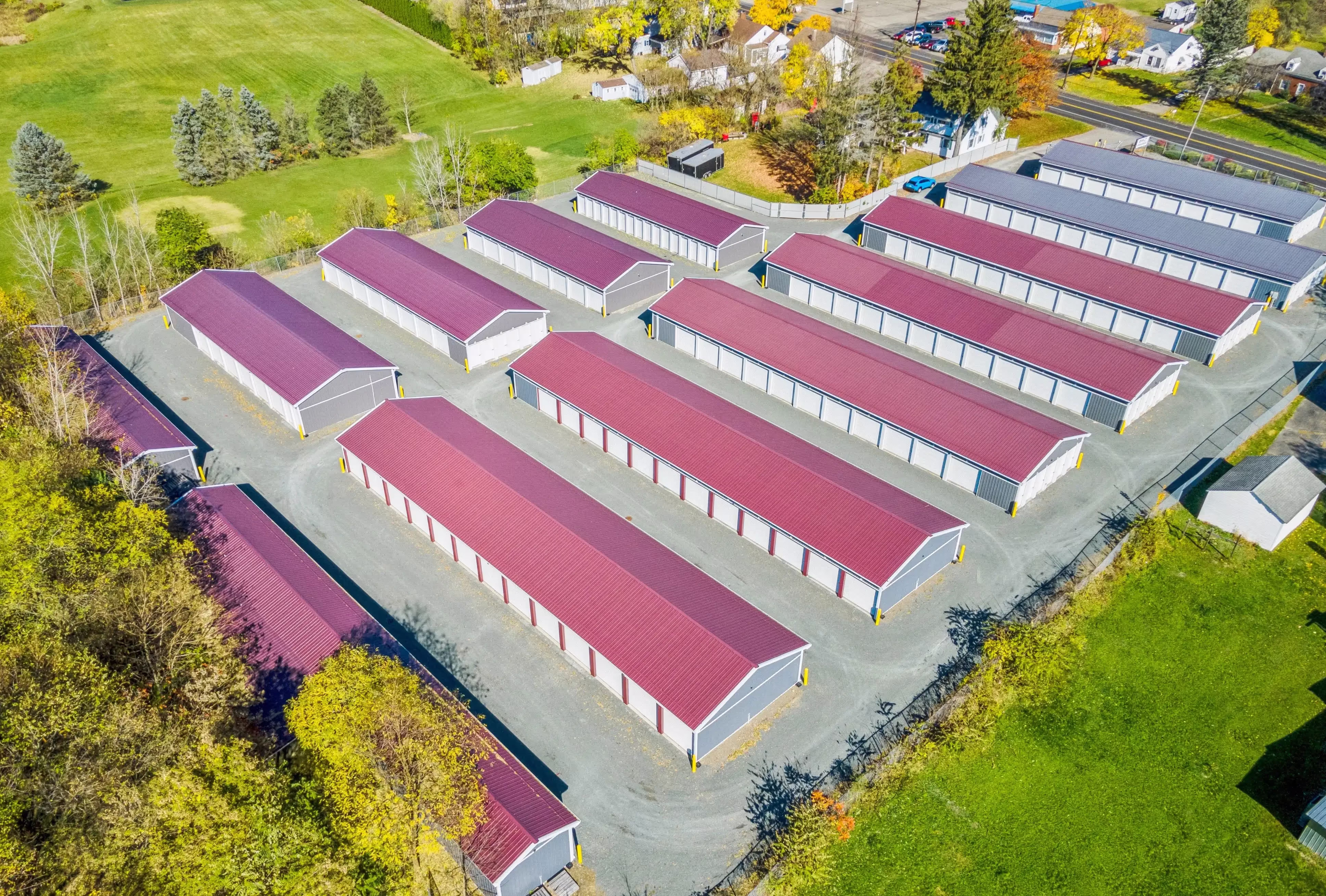 Aerial photo of drive up storage buildings with purple roofs and surrounding property in Elmira NY