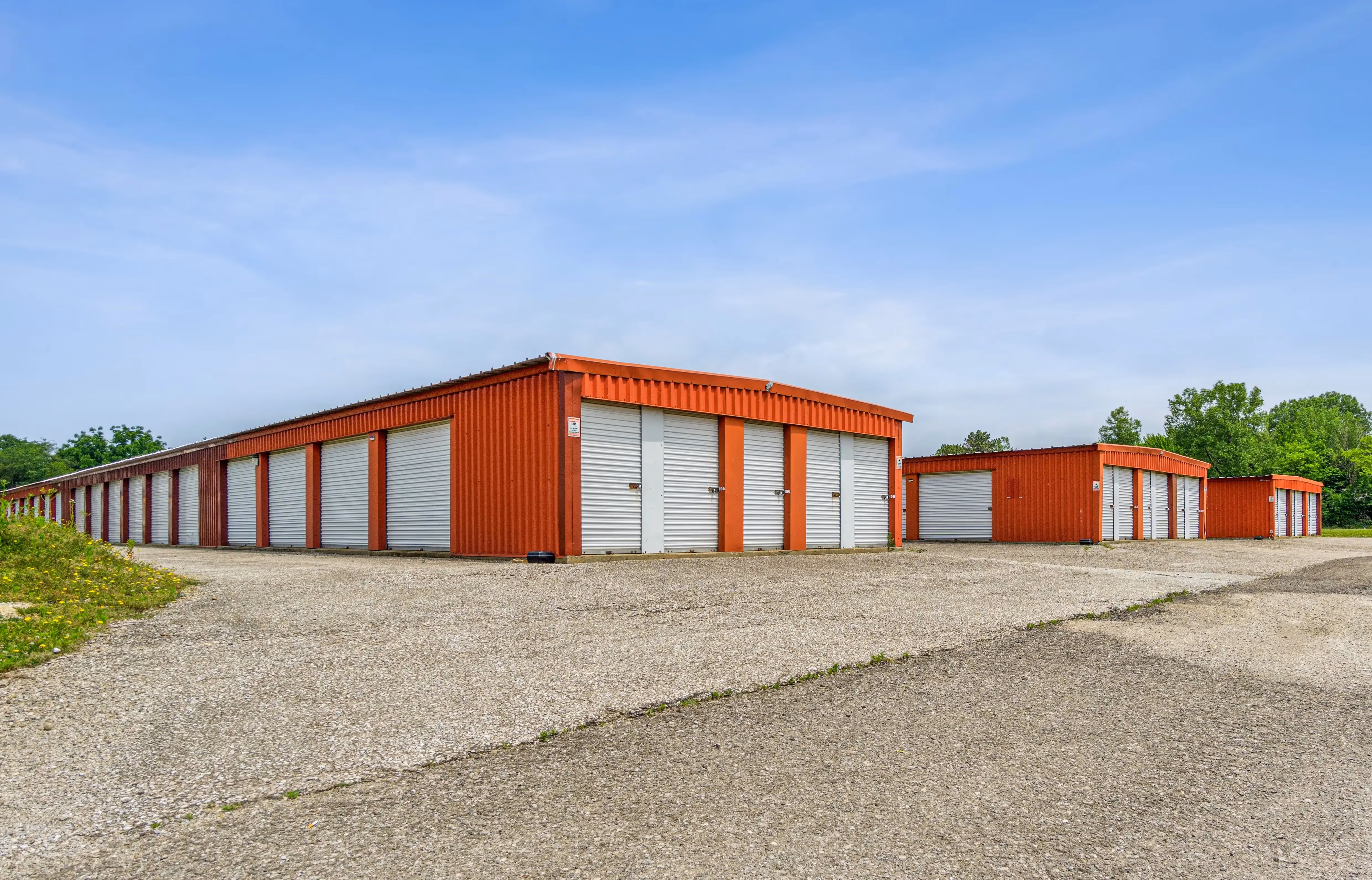 Wide view of several red storage buildings arranged around a shared gravel lot in Fairview PA