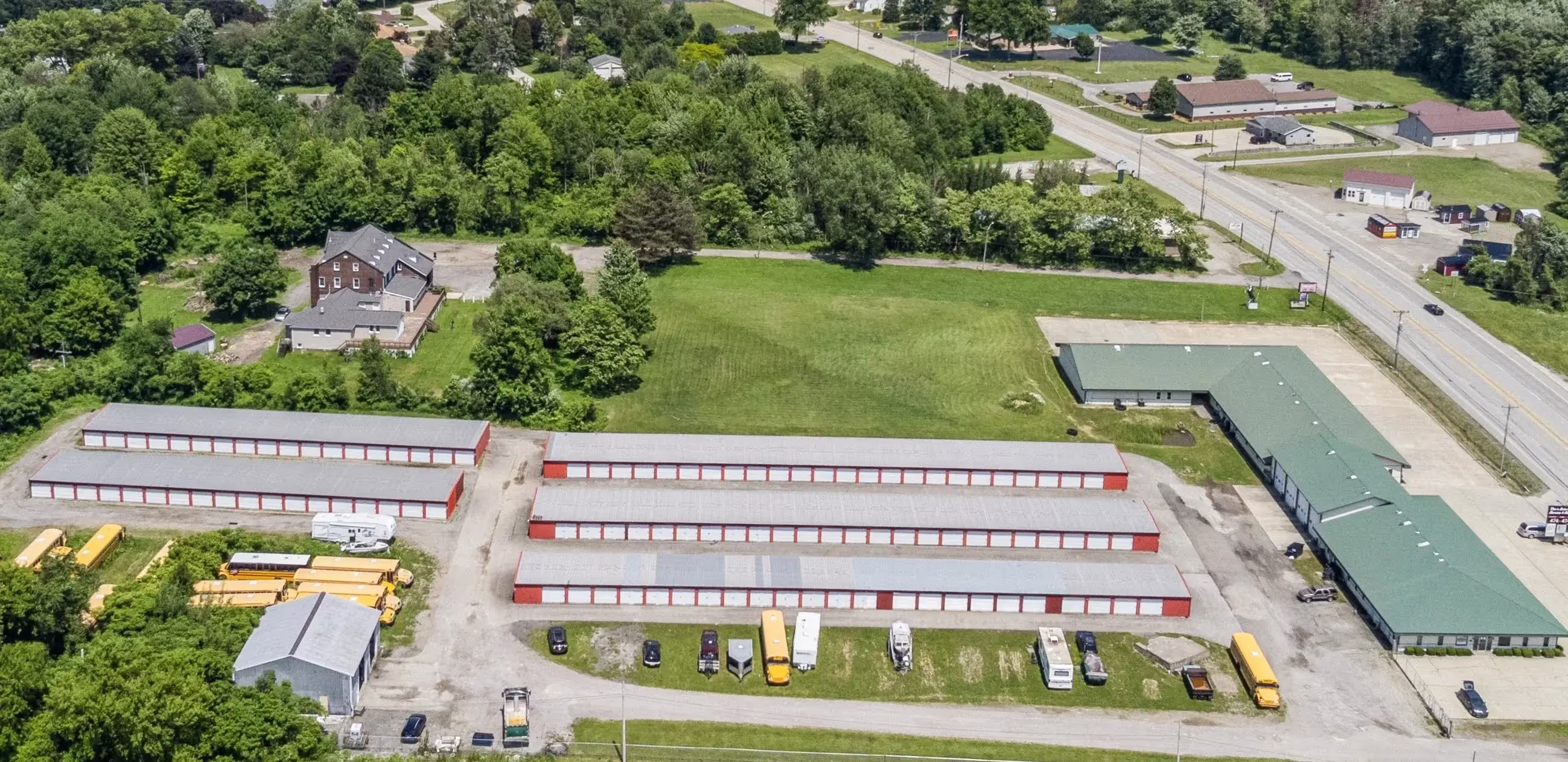 Aerial view of the Fairview PA storage facility showing multiple red storage buildings, drive lanes, and surrounding homes