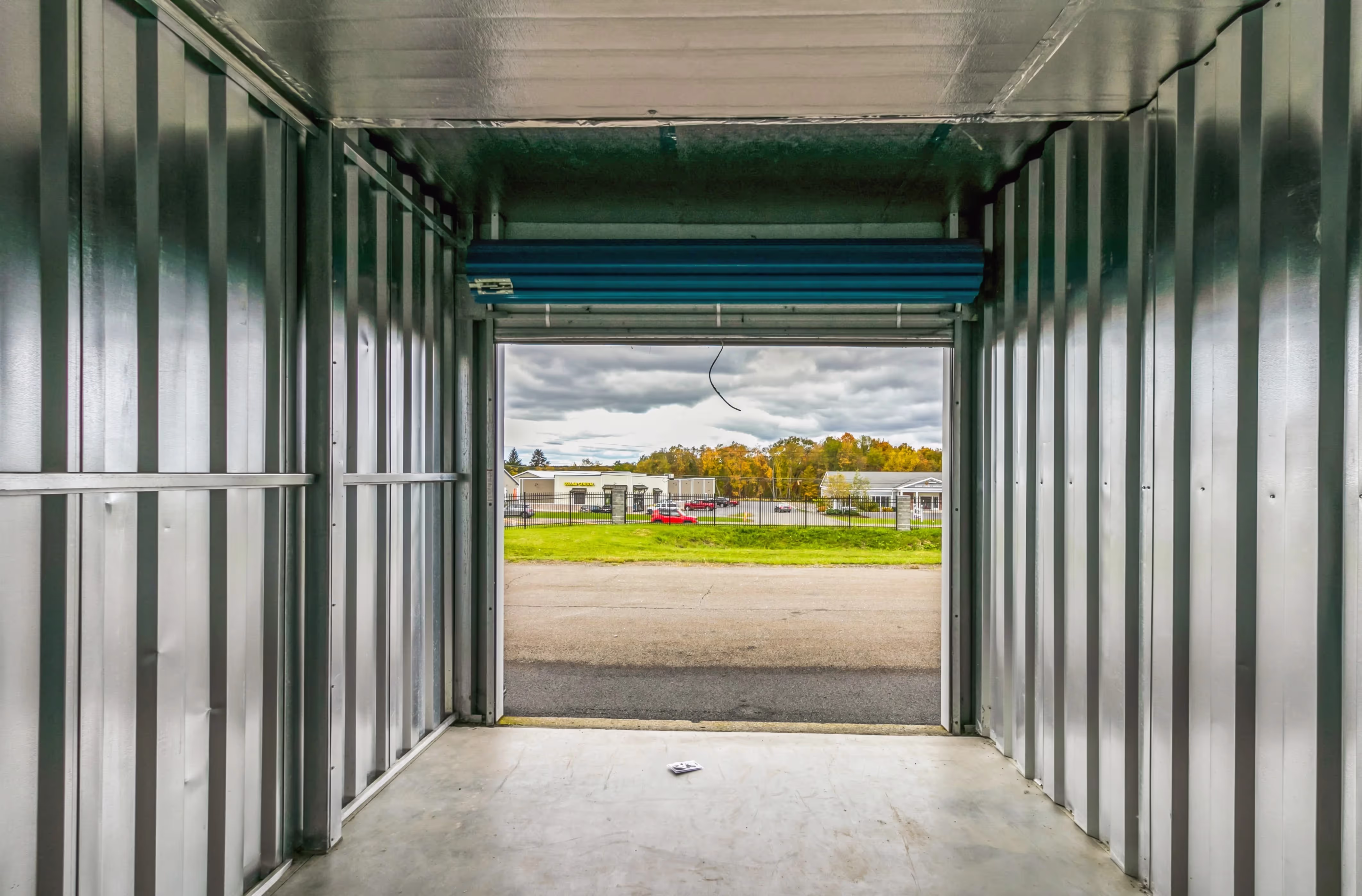 Open drive up storage unit with blue door at our Ithaca NY facility