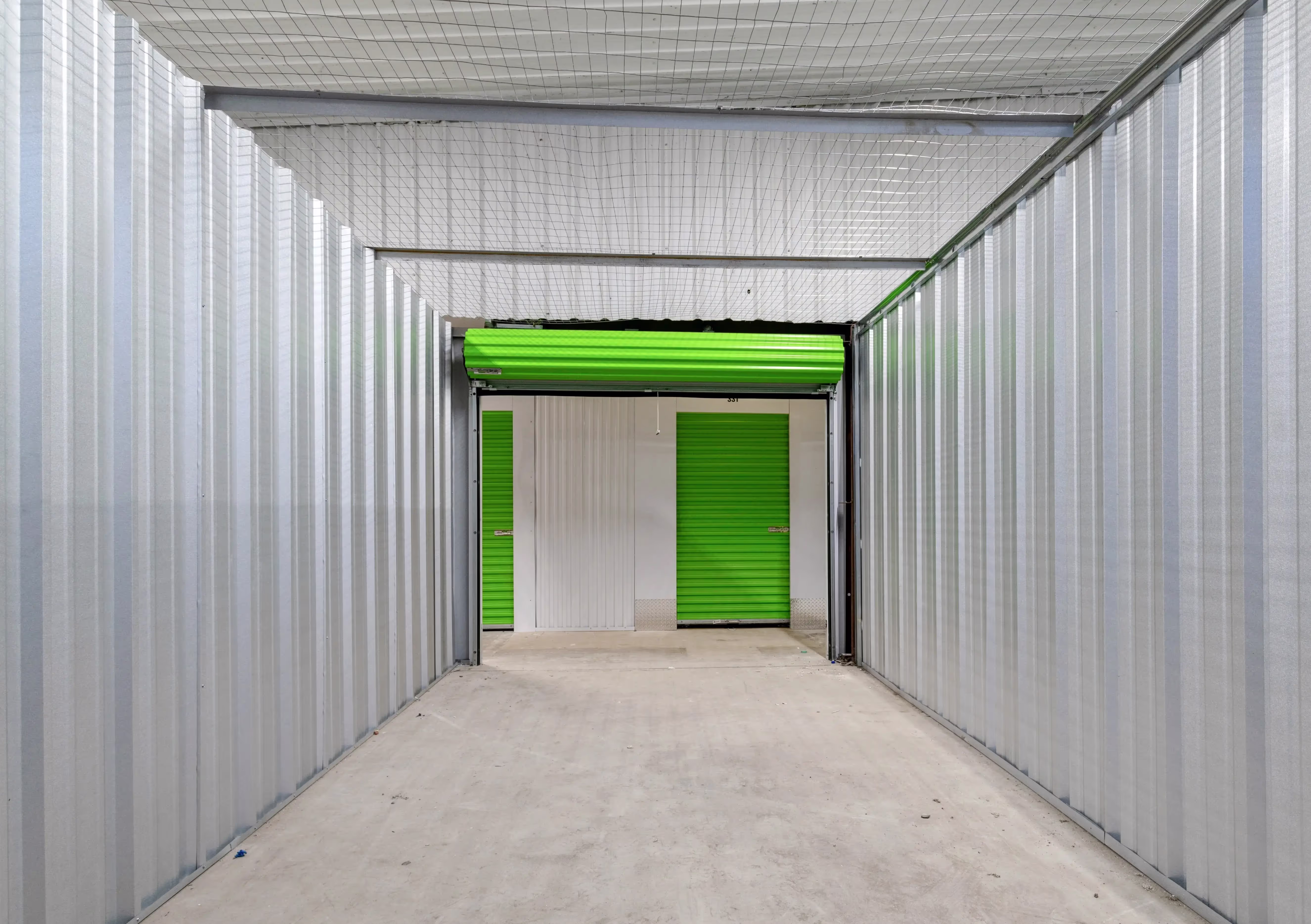 Open climate controlled storage unit with green roll up door at our Milledgeville GA location