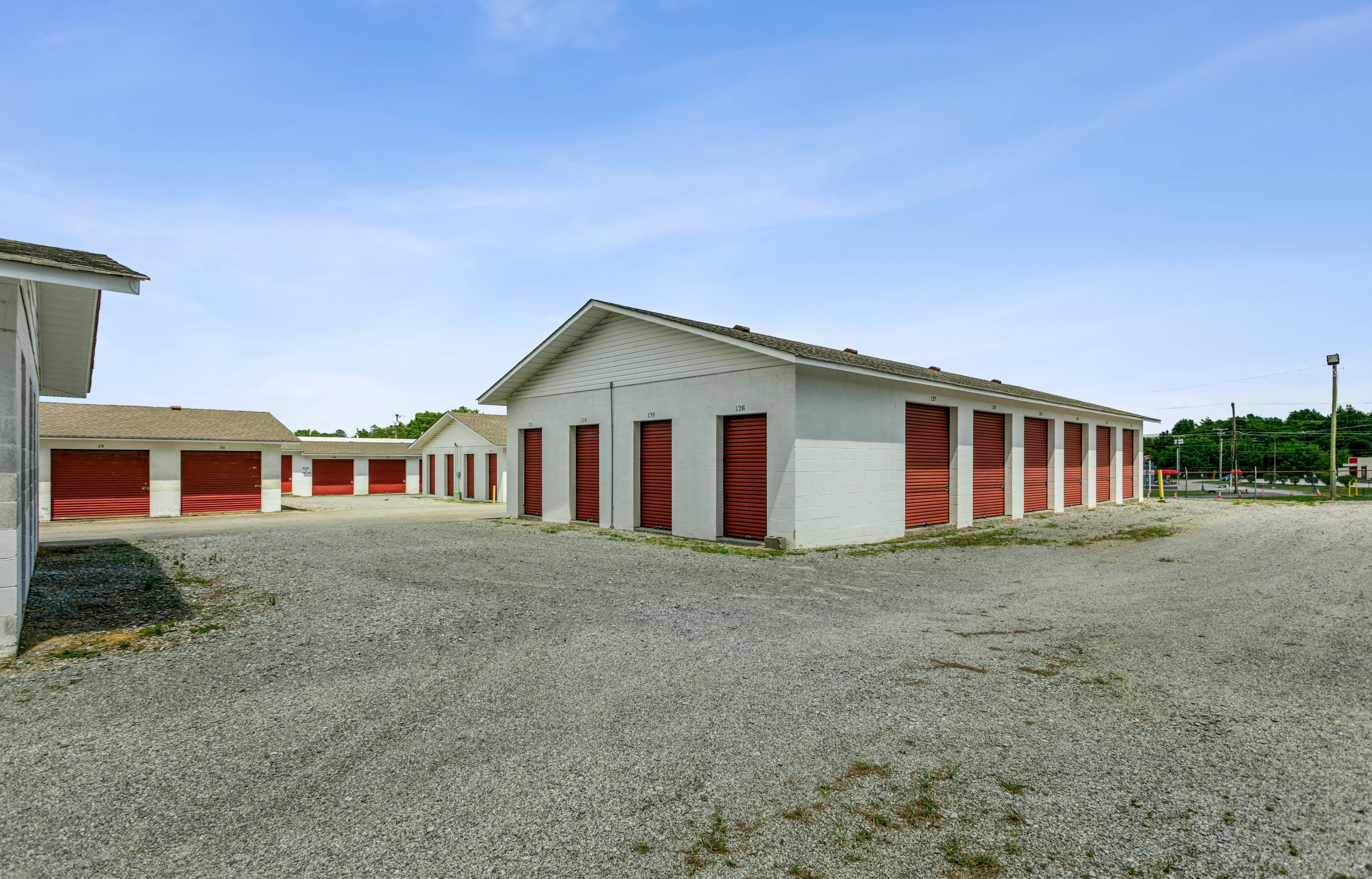 Exterior view of drive up storage buildings with red roll up doors at our LaFayette GA location