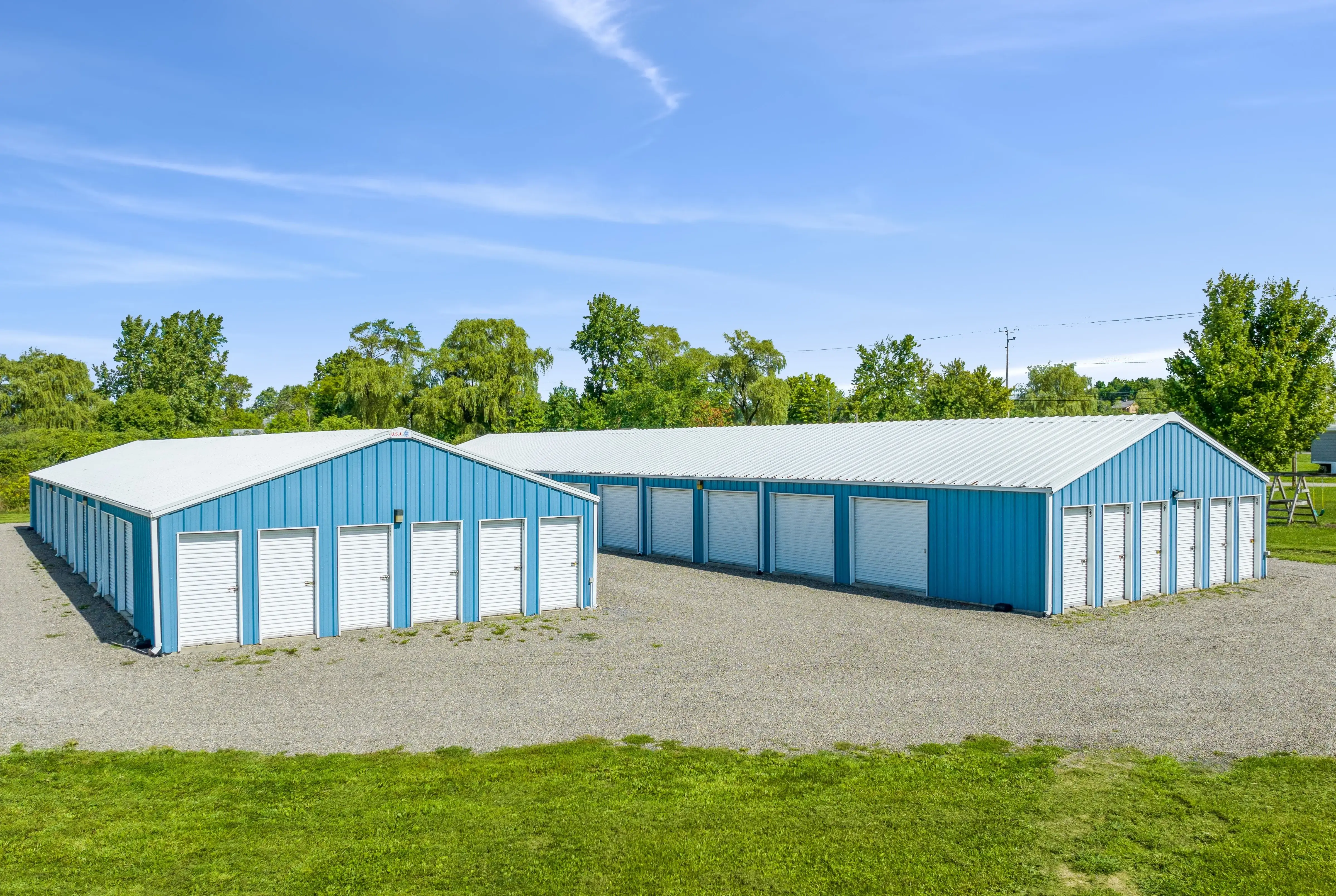 Fron view of our two self storage buildings with white doors in Lansing, NY