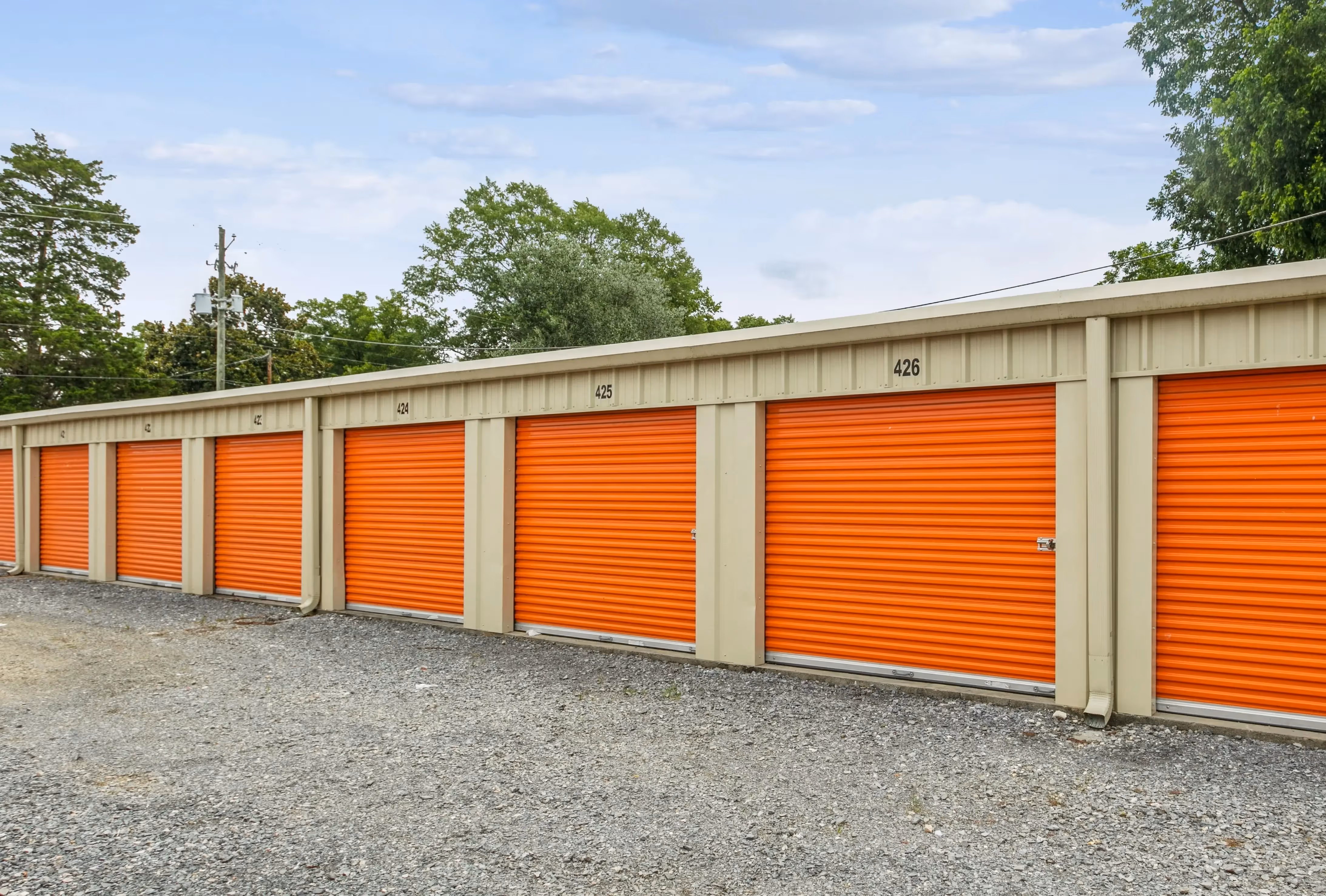 Row of orange door storage units along gravel driveways at our Lyerly GA facility