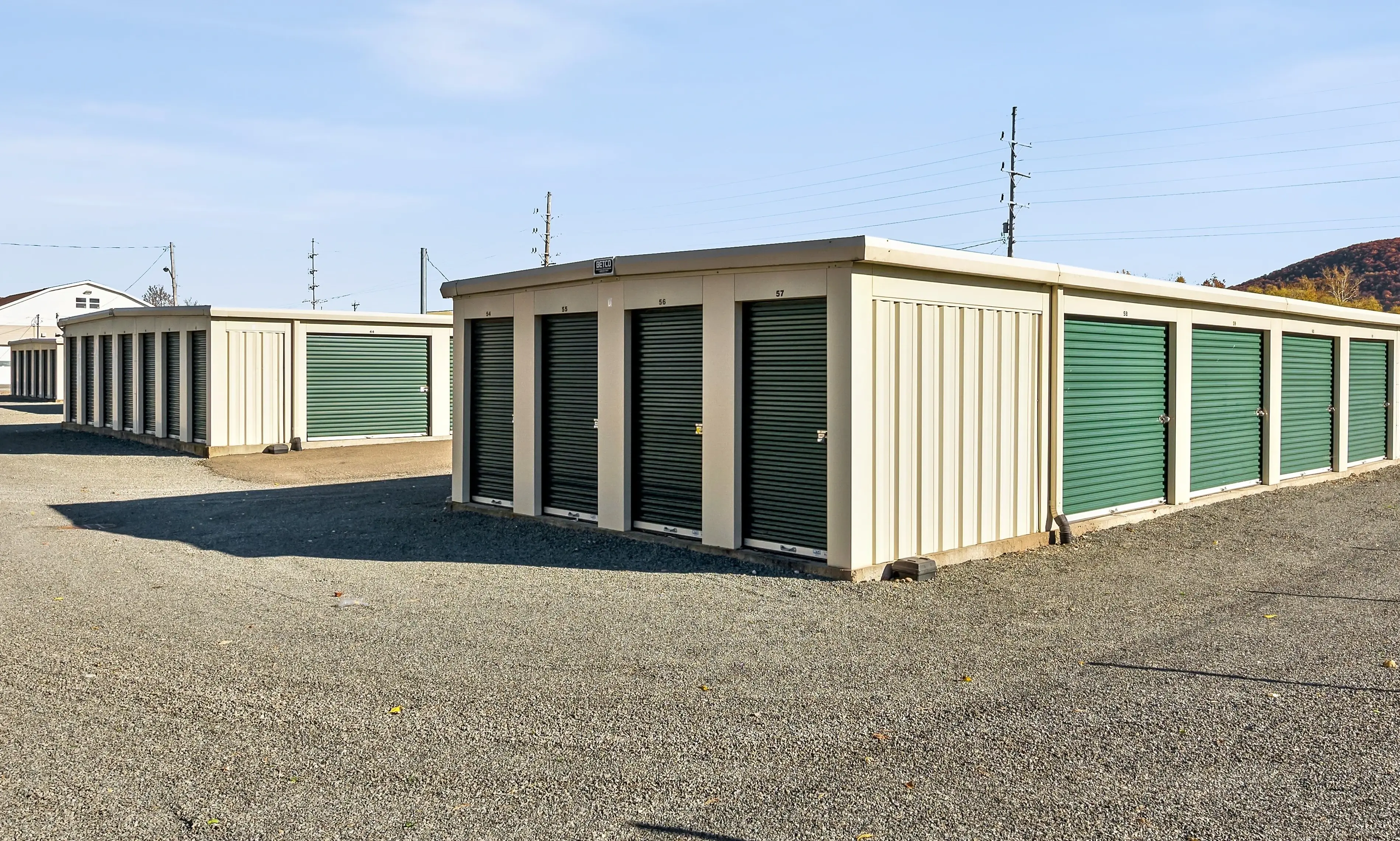 Angled view of drive up storage buildings with green doors at our Elmira NY facility