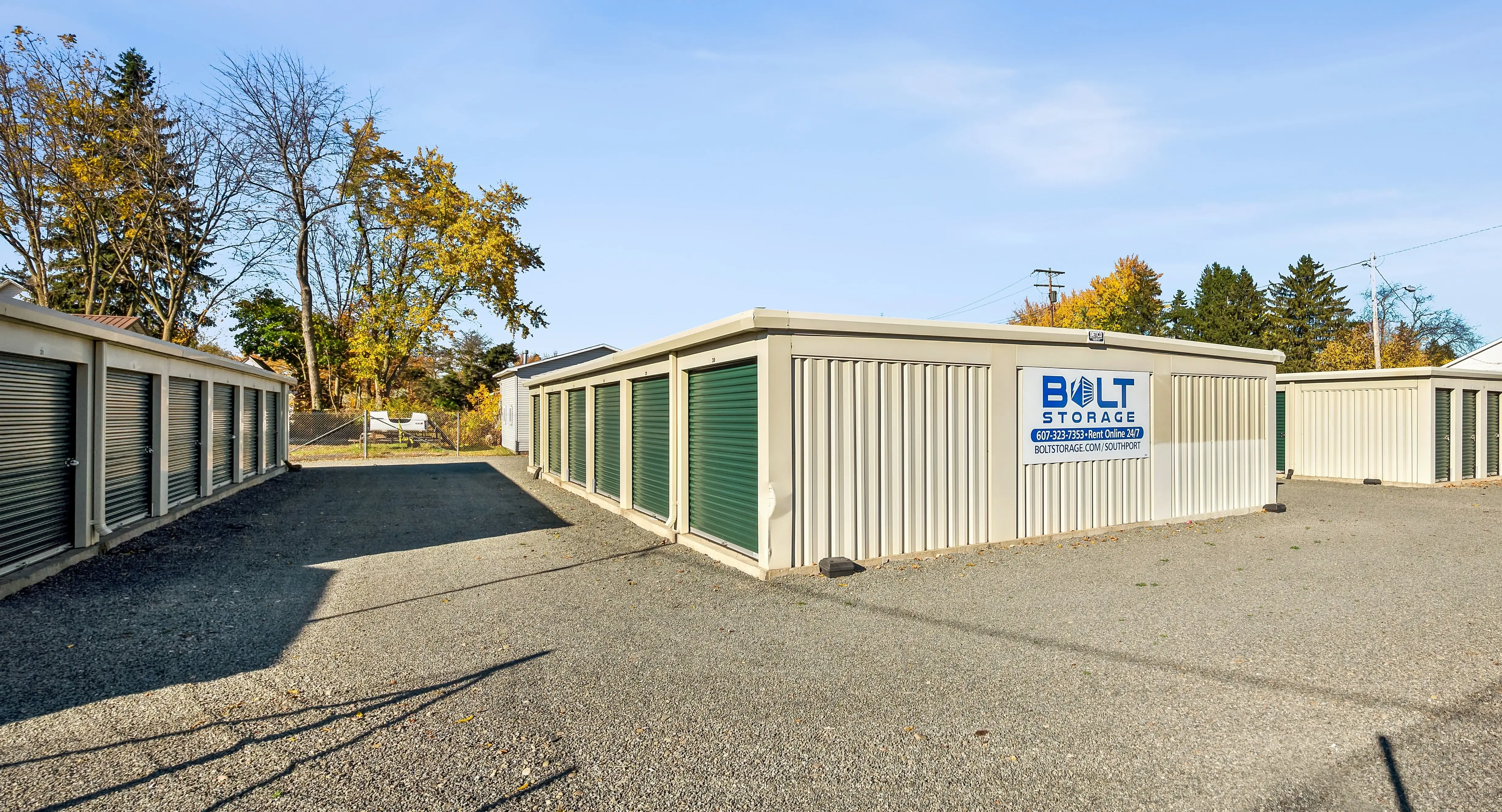 Exterior view of drive up storage units with green roll up doors at our Elmira NY location