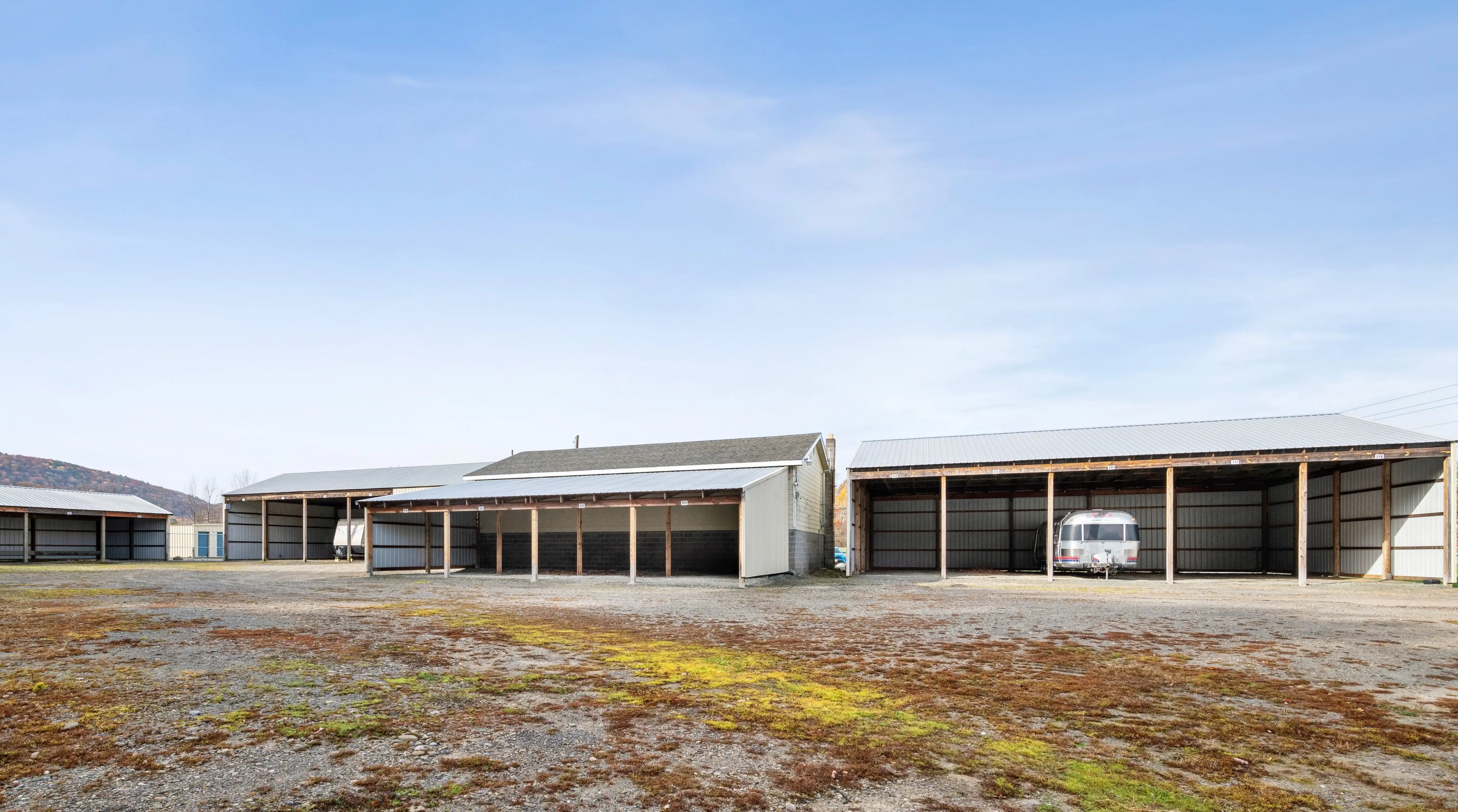 Angled view of storage buildings with blue doors and covered parking structure at our Elmira NY facility