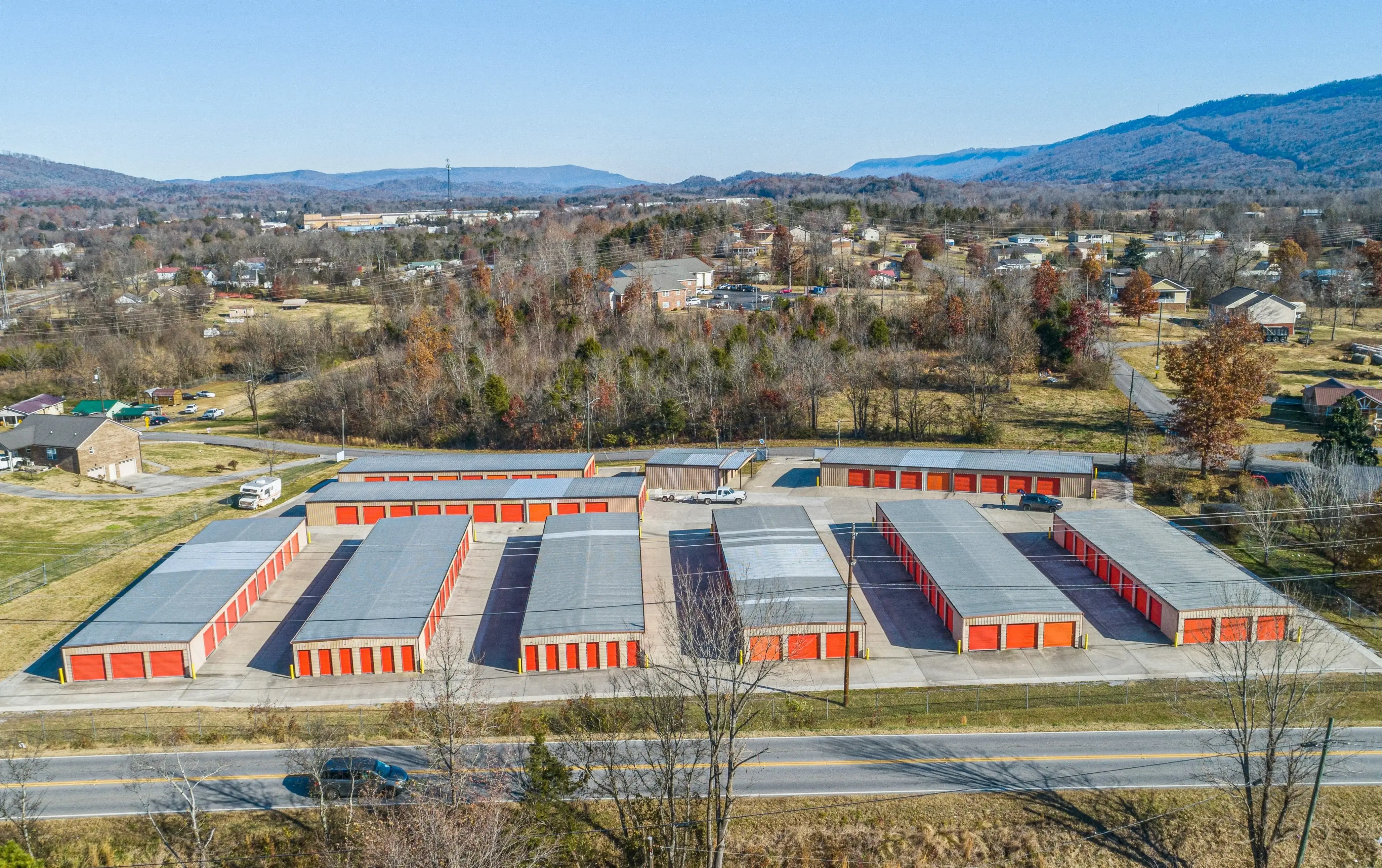erial view of the Trenton GA storage facility showing multiple rows of red roll up units surrounded by hills and trees