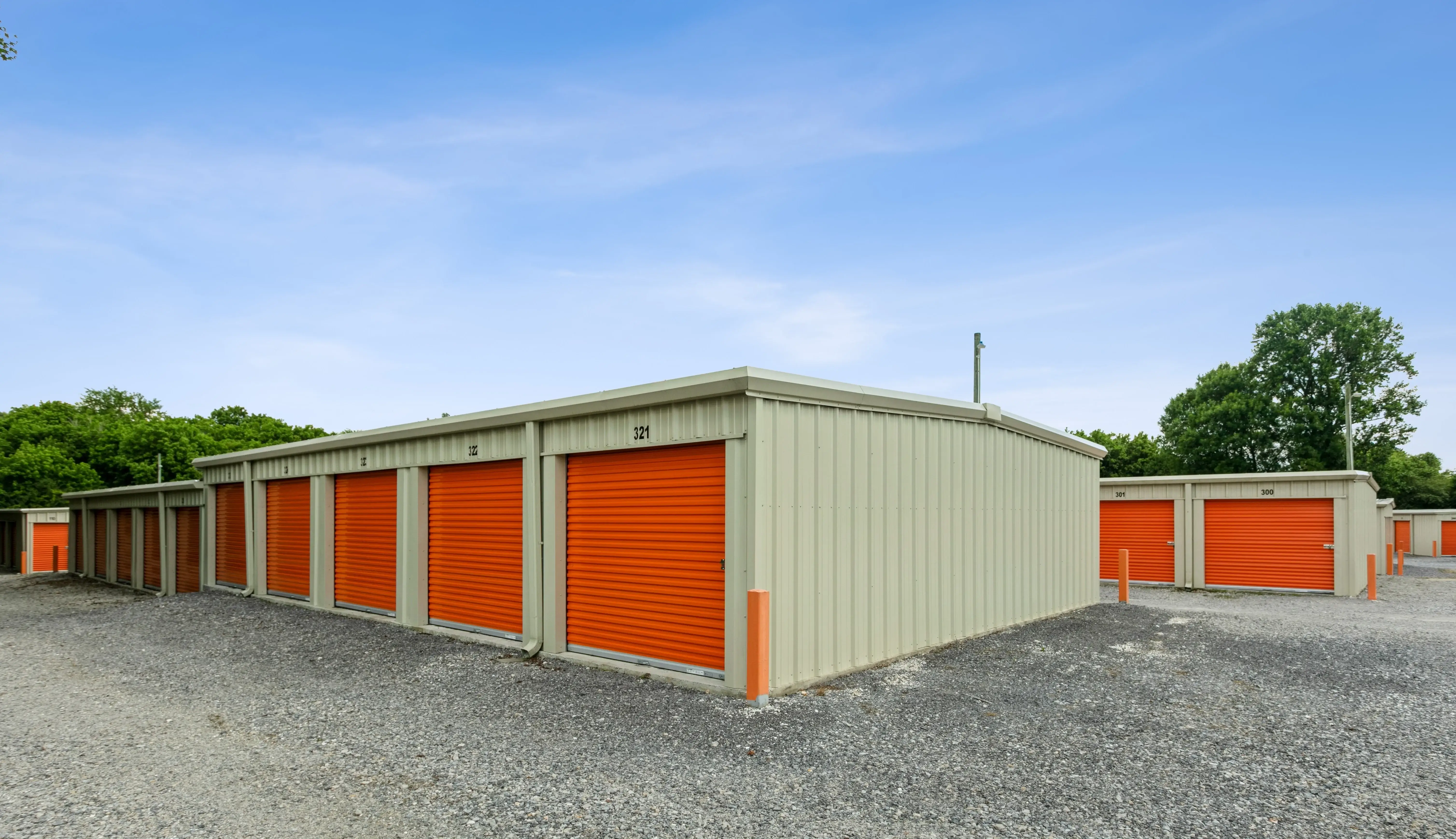 Angled view of orange roll up storage units on a gravel lot with trees in the background at our Trion GA facility