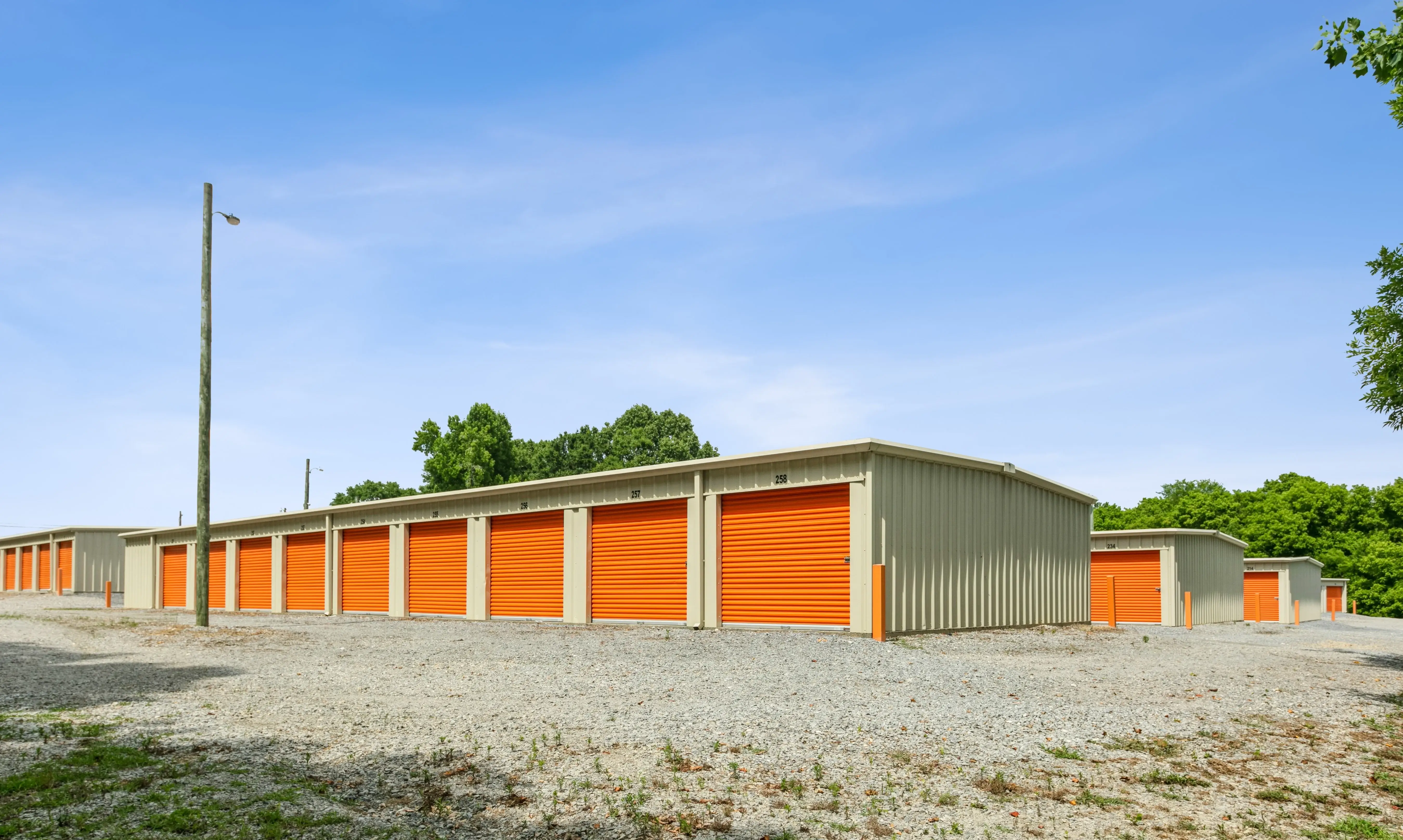 Wide view of multiple storage buildings arranged around an open gravel area at our Trion GA location