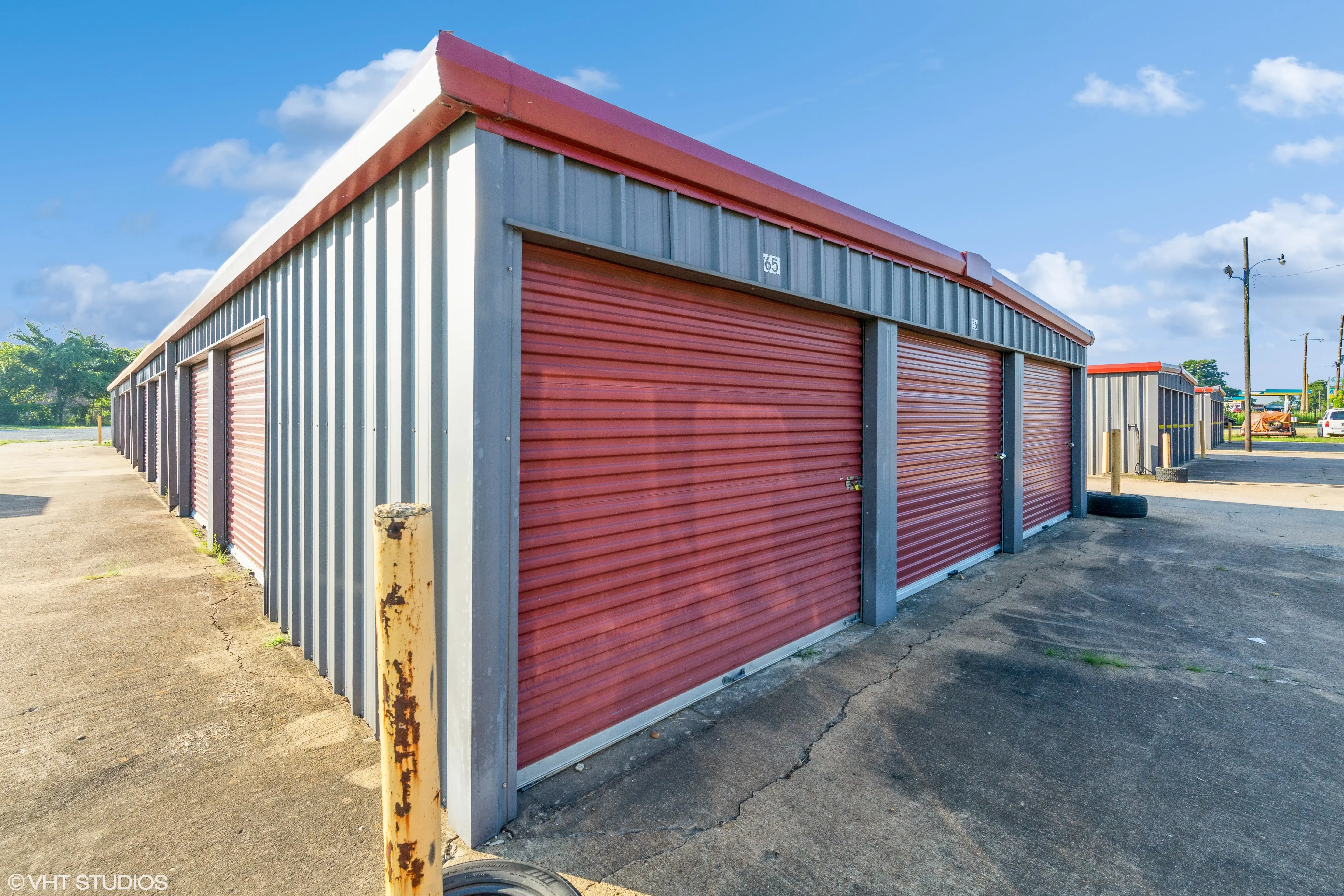 Angled view of red roll up storage units on a raised gravel pad at our Walls MS facility