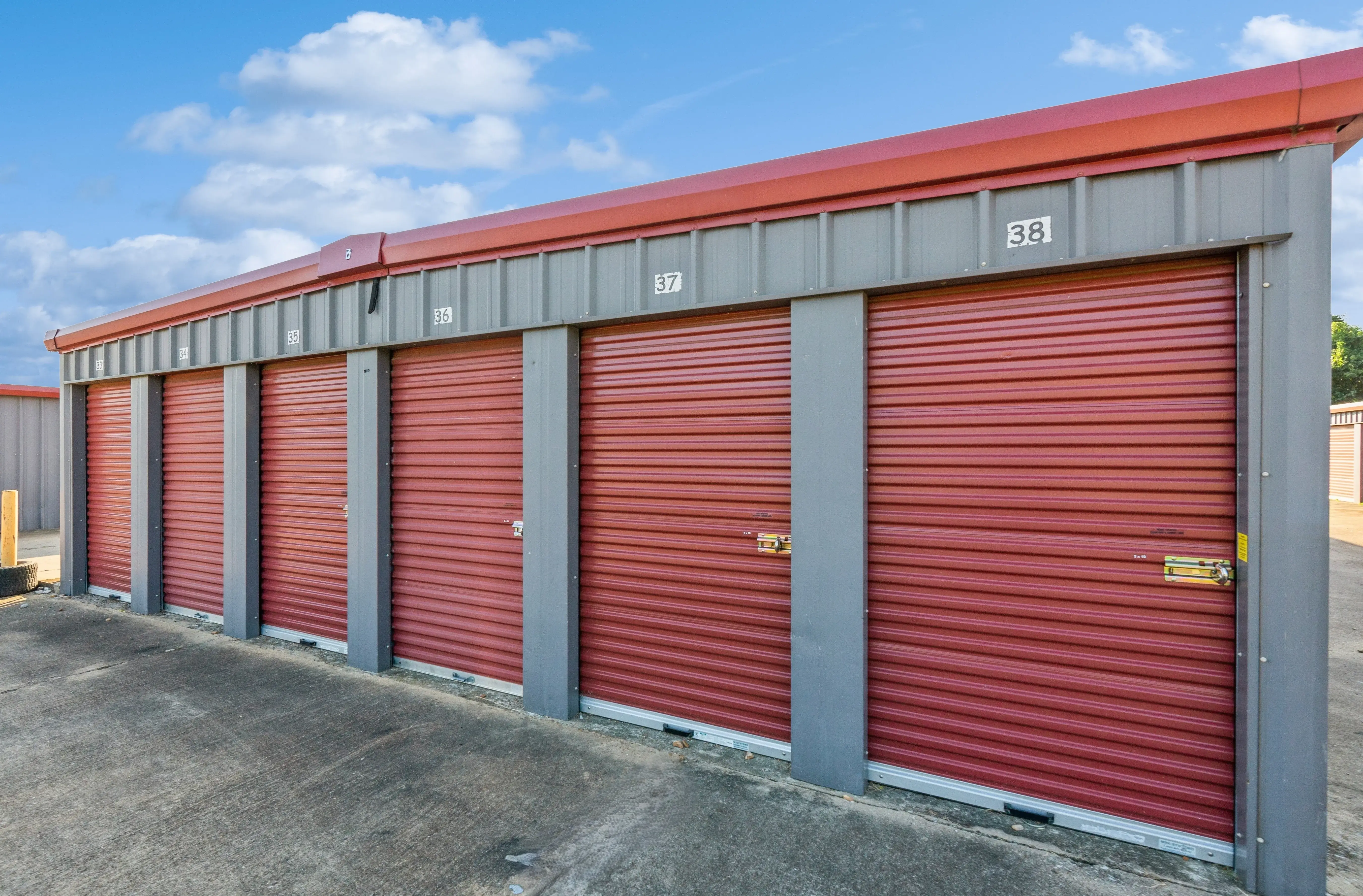 Angled view of red roll up storage units on a raised gravel pad at our Walls MS facility