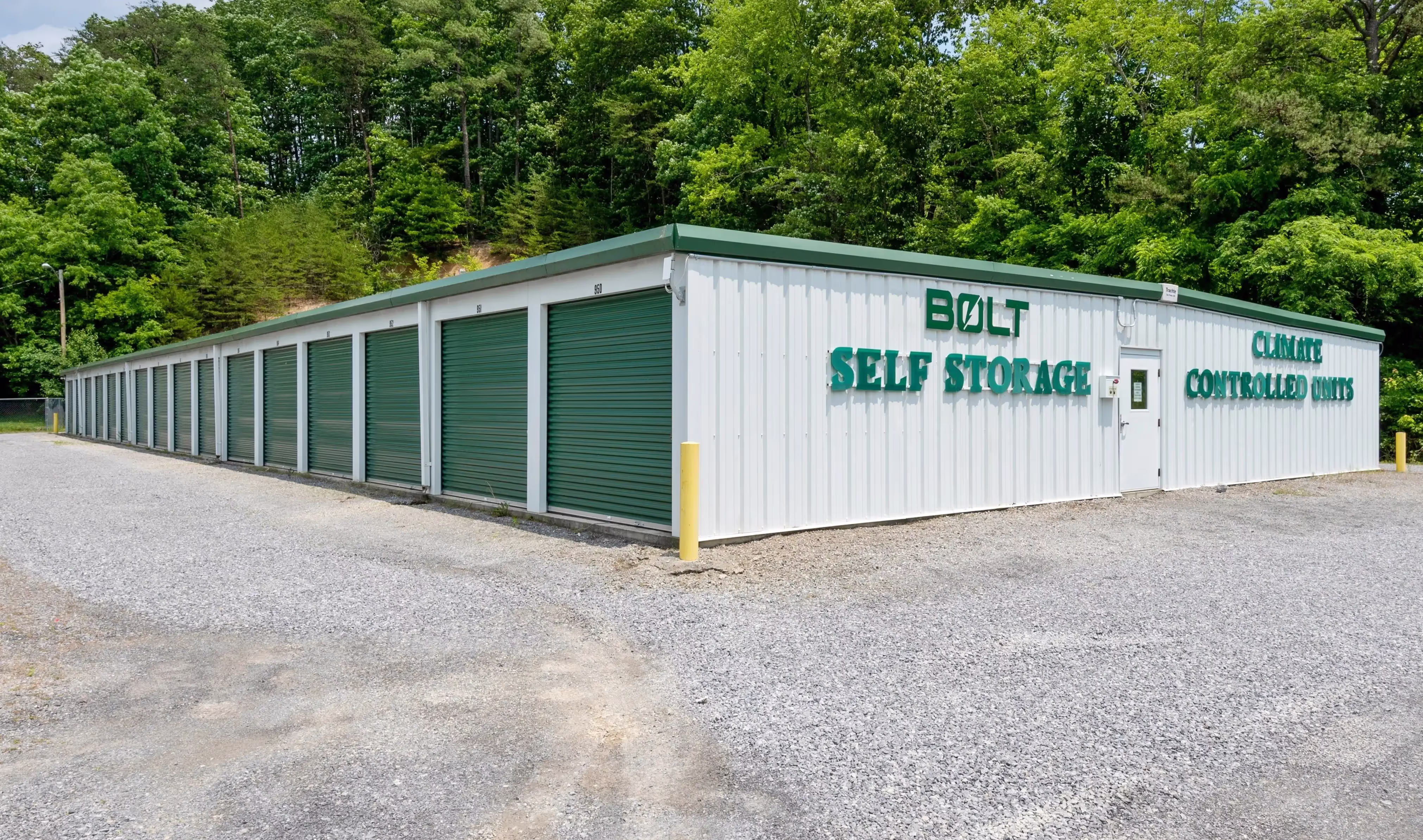 Storage building with green roll up doors and facility sign at our Abingdon VA storage location