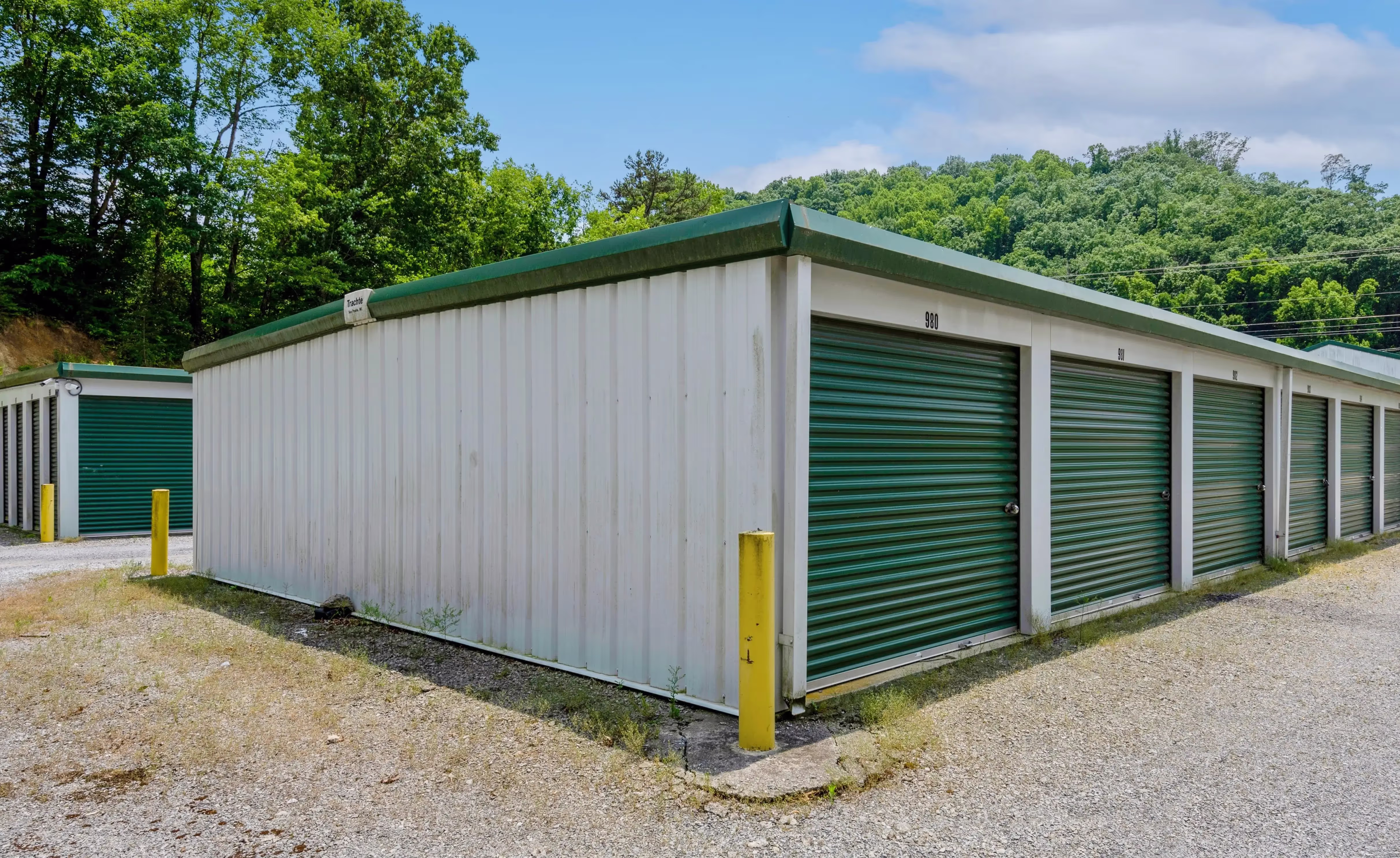 Drive up storage buildings with green doors and paved access lane at our Abingdon VA facility