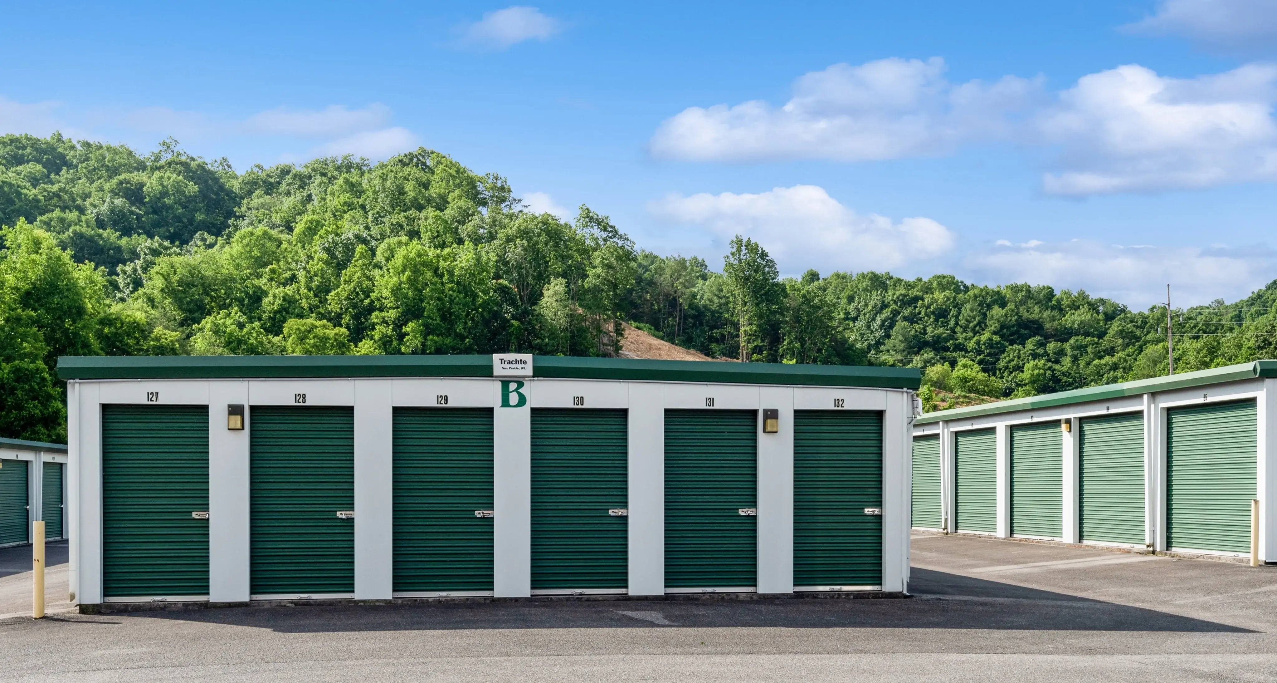 Row of drive up storage units with green roll up doors in Abingdon VA