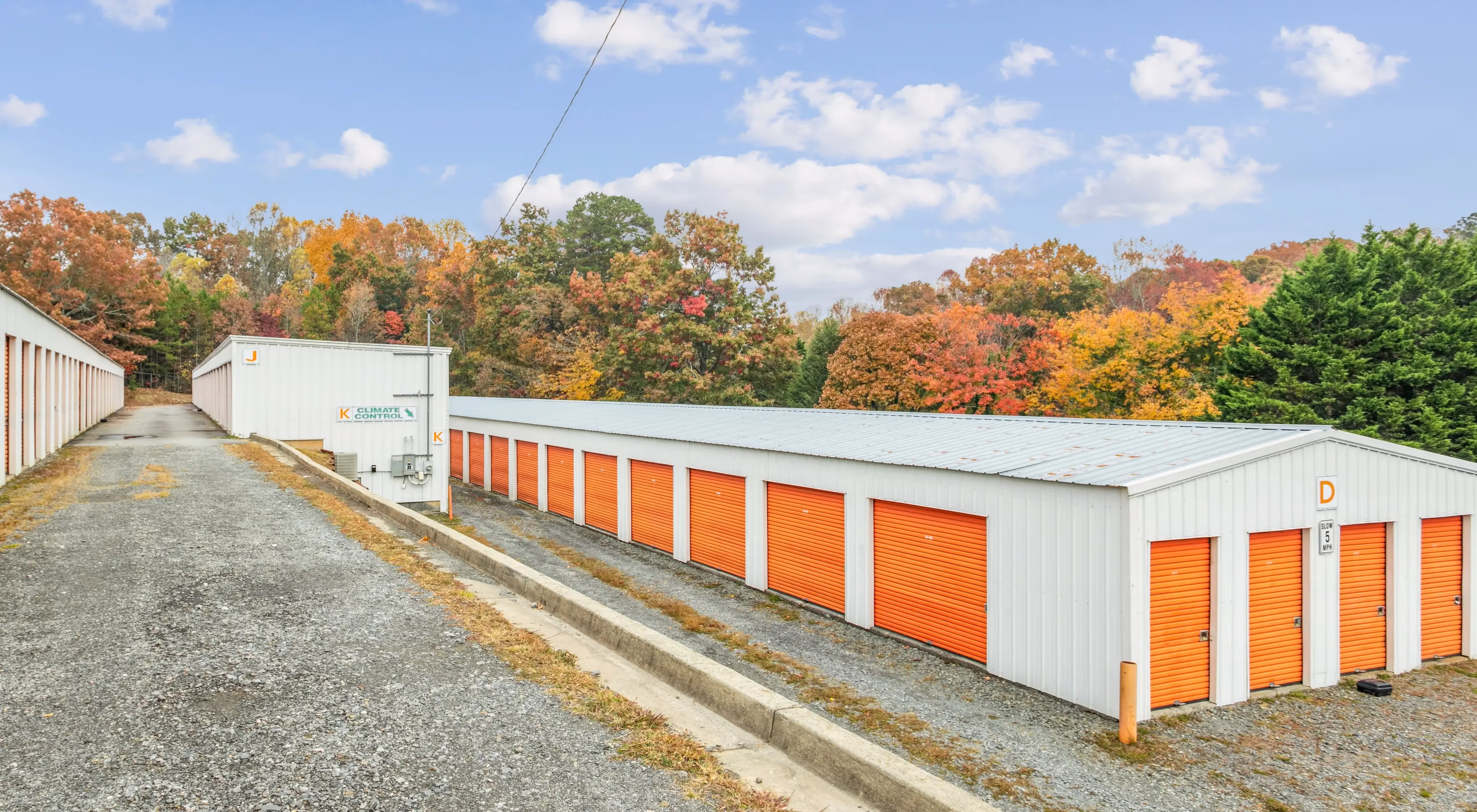 Row of drive up storage units with orange doors at our Ellijay GA facility
