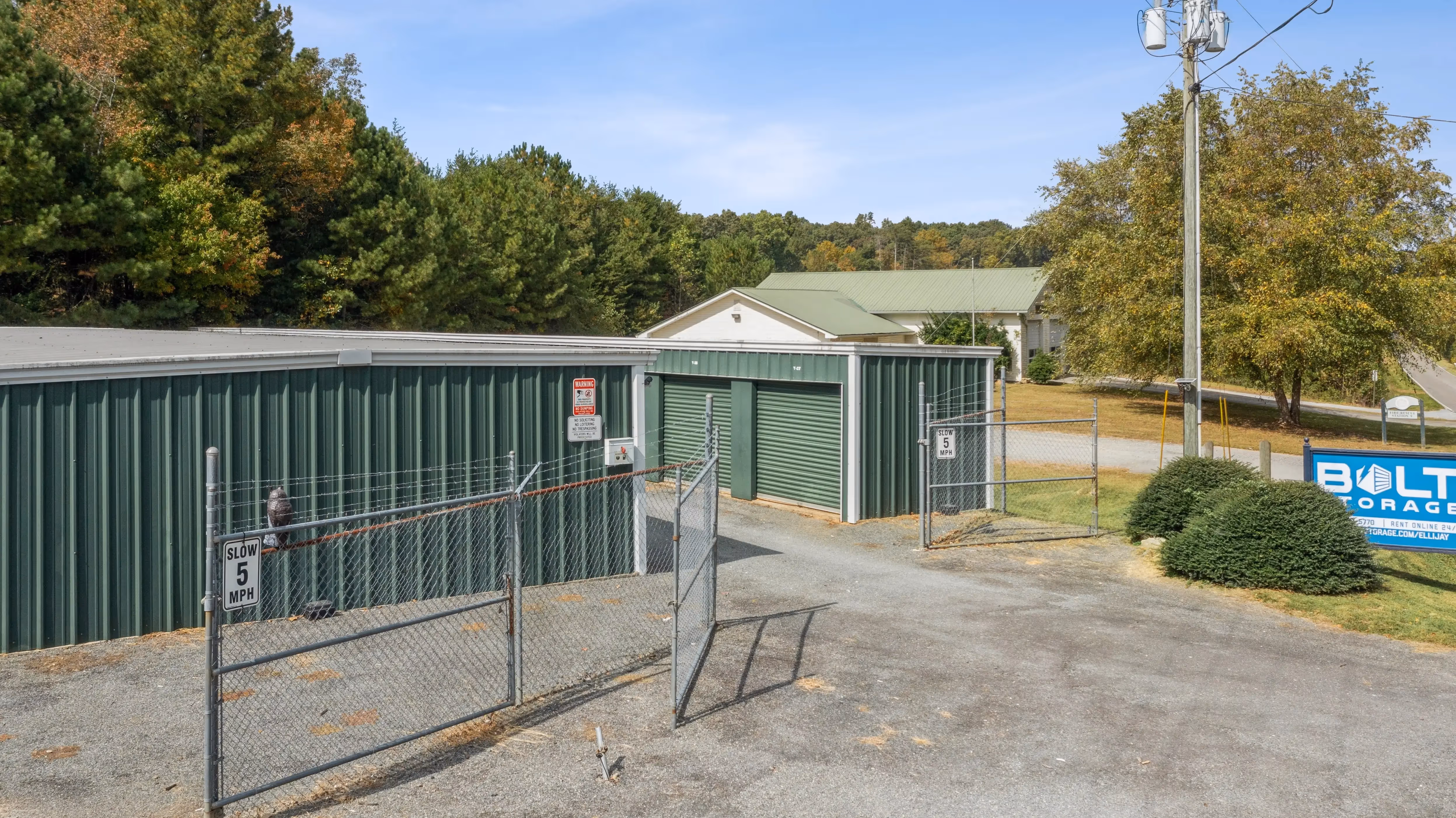 Facility access point with metal security gate and a mix of angled storage buildings at our Ellijay GA location