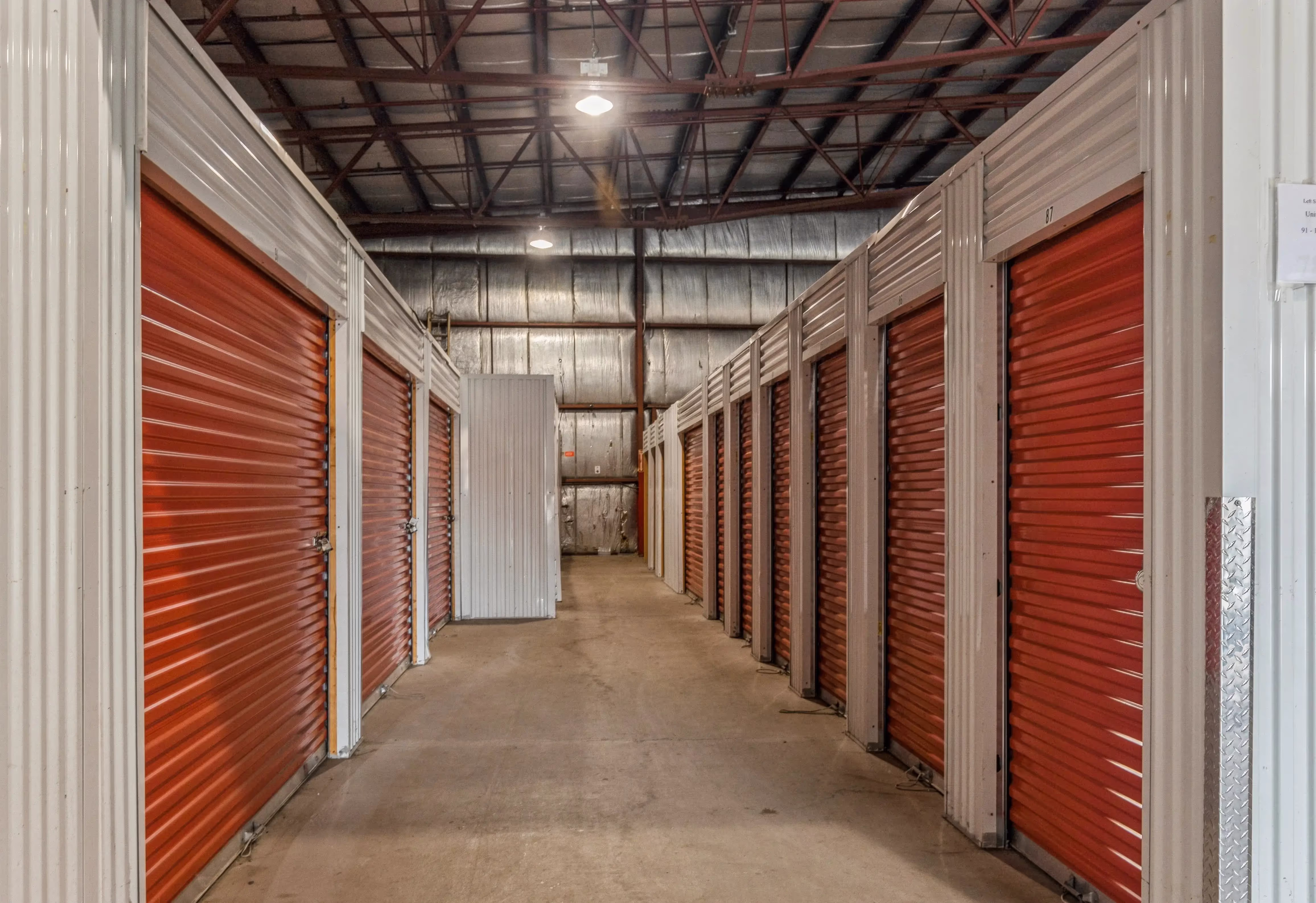 Interior hallway with red roll up doors at our Gloversville NY self storage facility